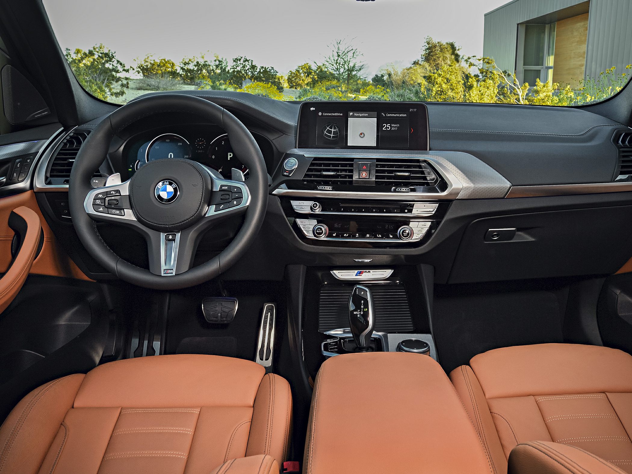 Luxury SUV interior with dashboard, steering wheel, infotainment screen