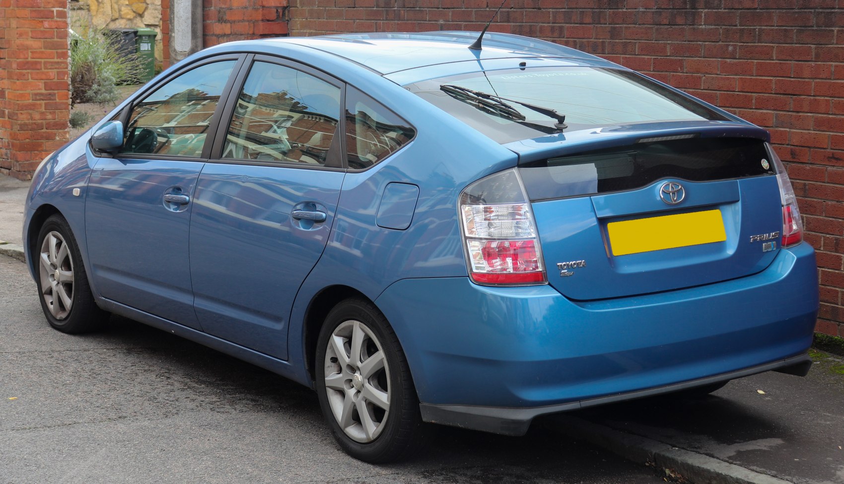 Rear and side profile of a hybrid hatchback with aerodynamic design and clear tail lights.