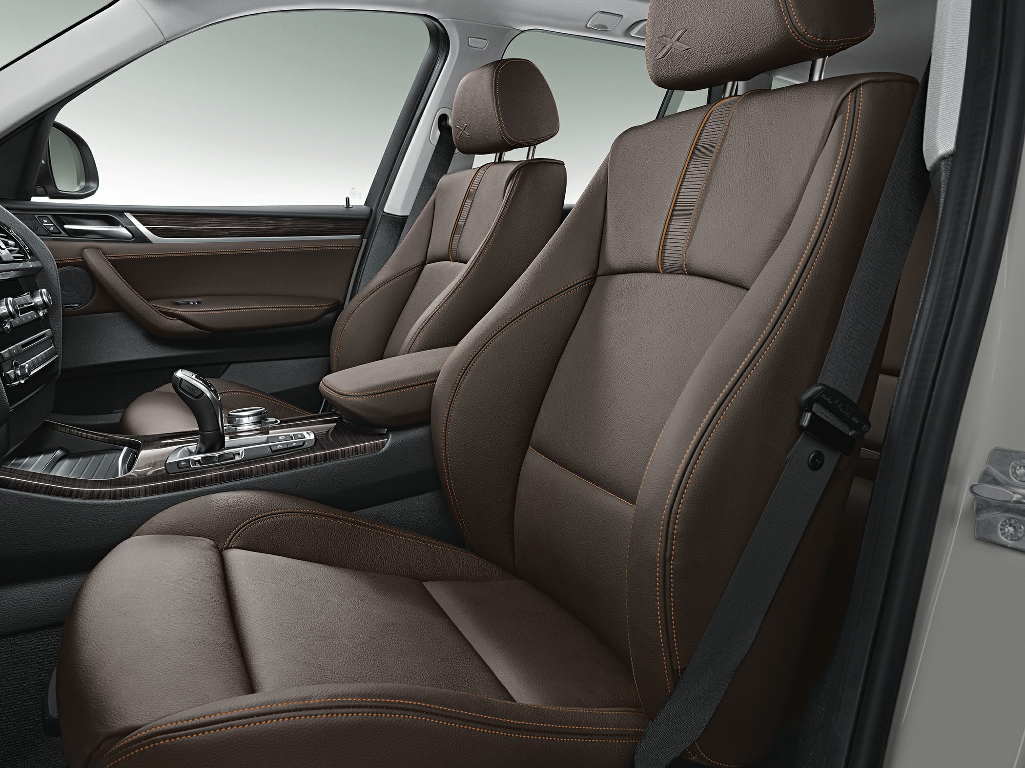 Brown leather front seats with contrast stitching and wood trim