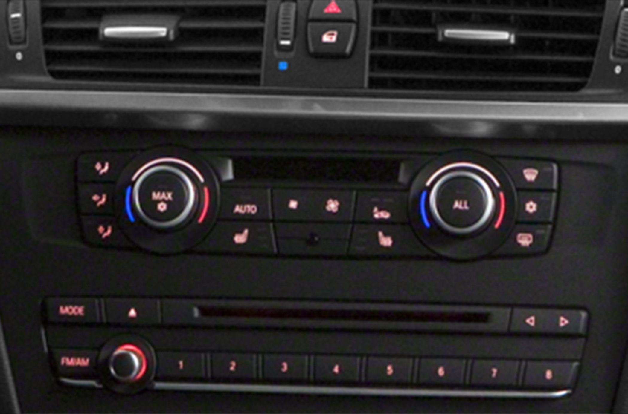 Dual zone climate control panel with temperature dials and buttons