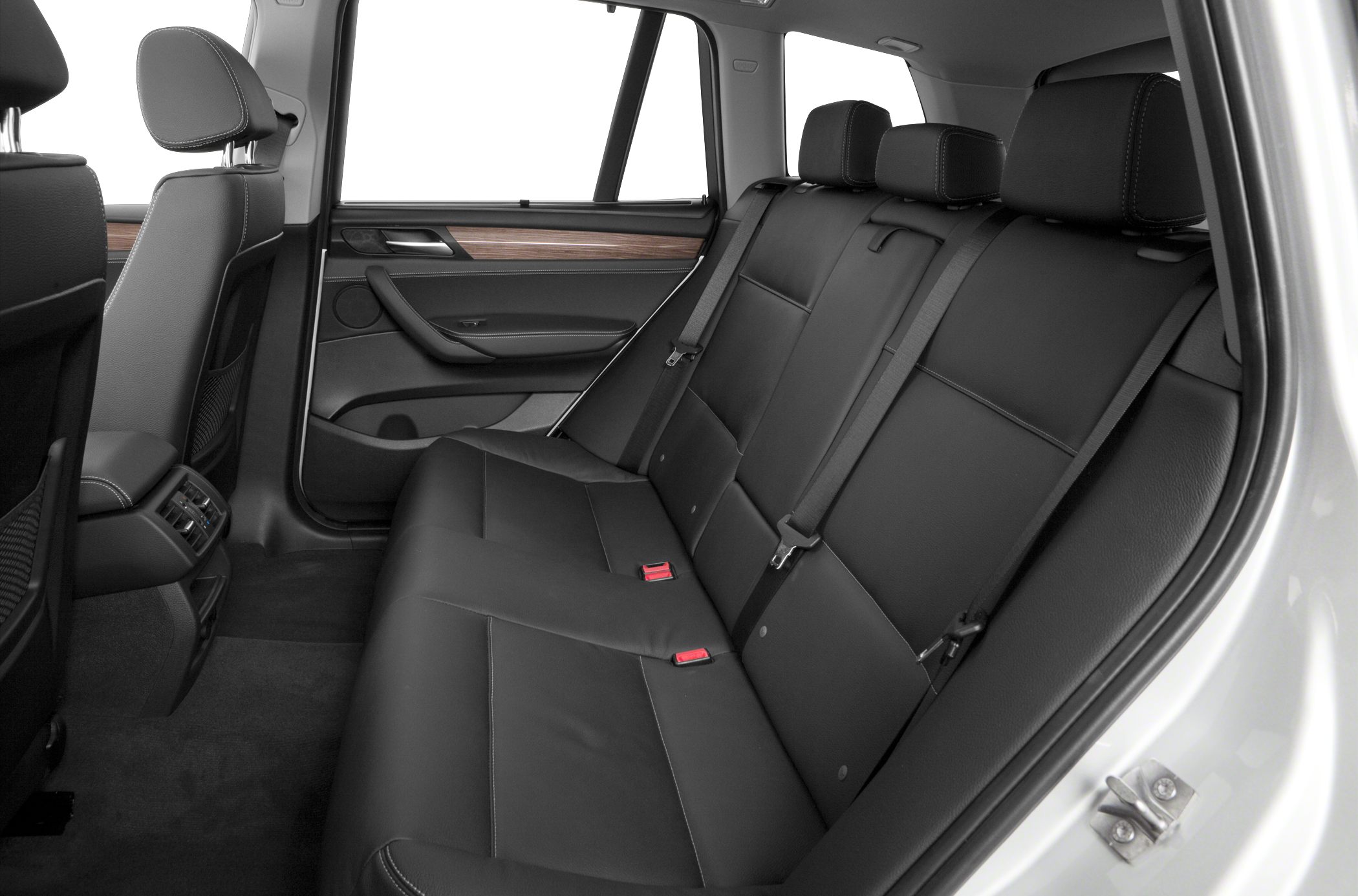 Spacious black leather rear passenger seating with wood trim