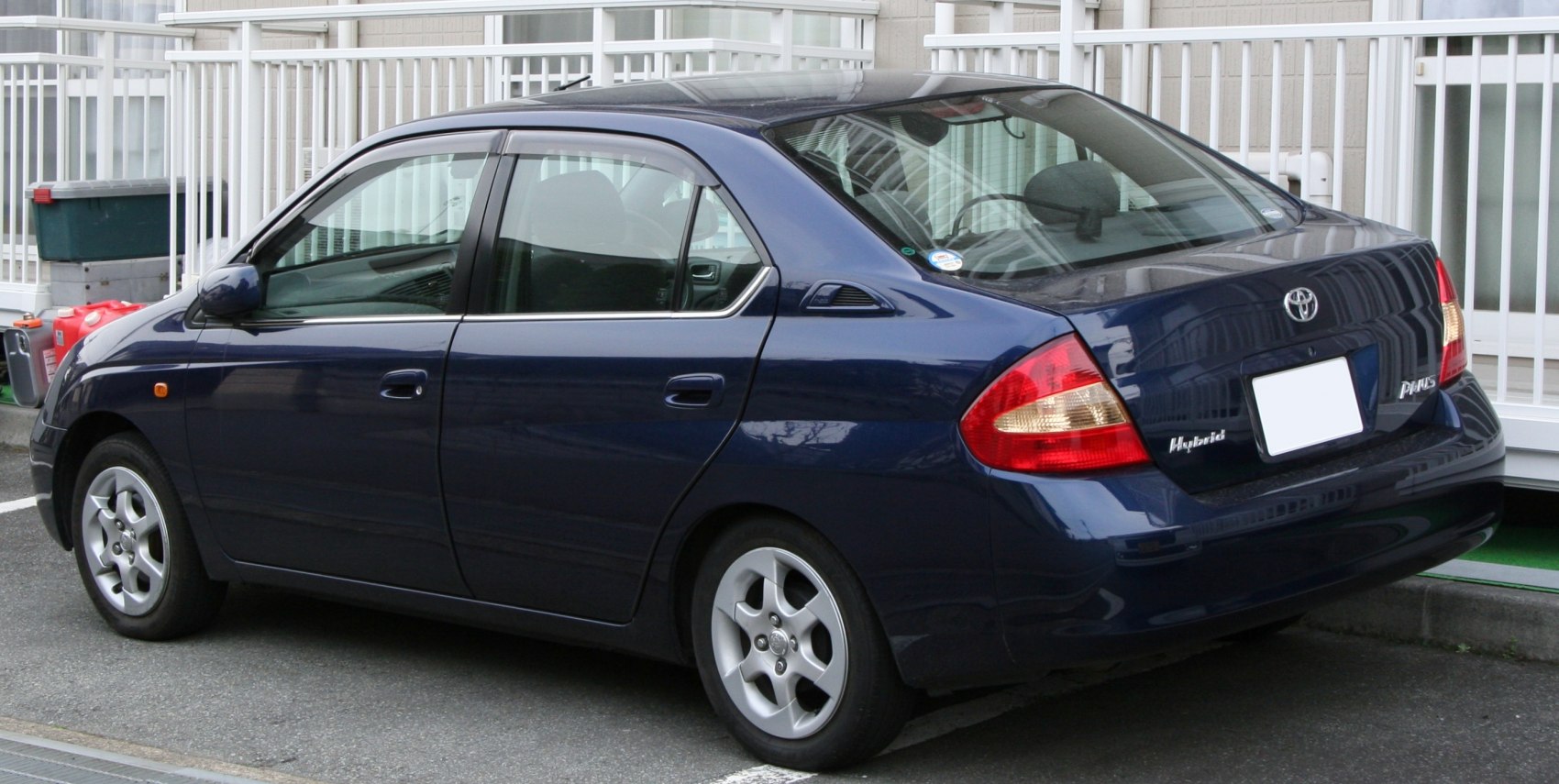 Rear and side profile of a hybrid sedan with distinctive taillights and hybrid badging