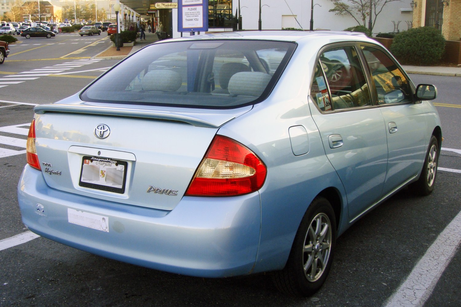 Rear of light blue hybrid sedan with spoiler and taillights
