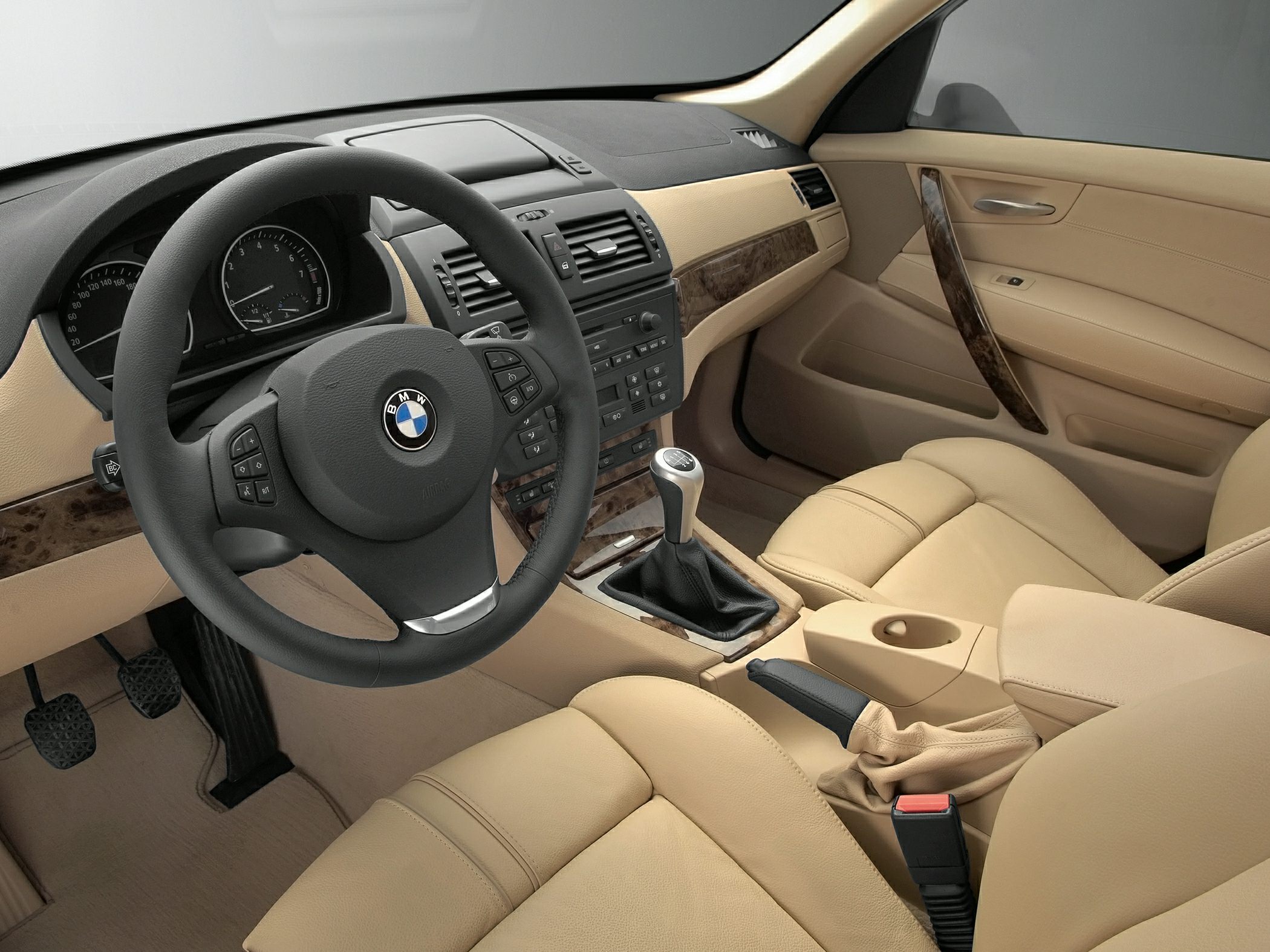 Beige leather interior with wood trim and manual gear shift
