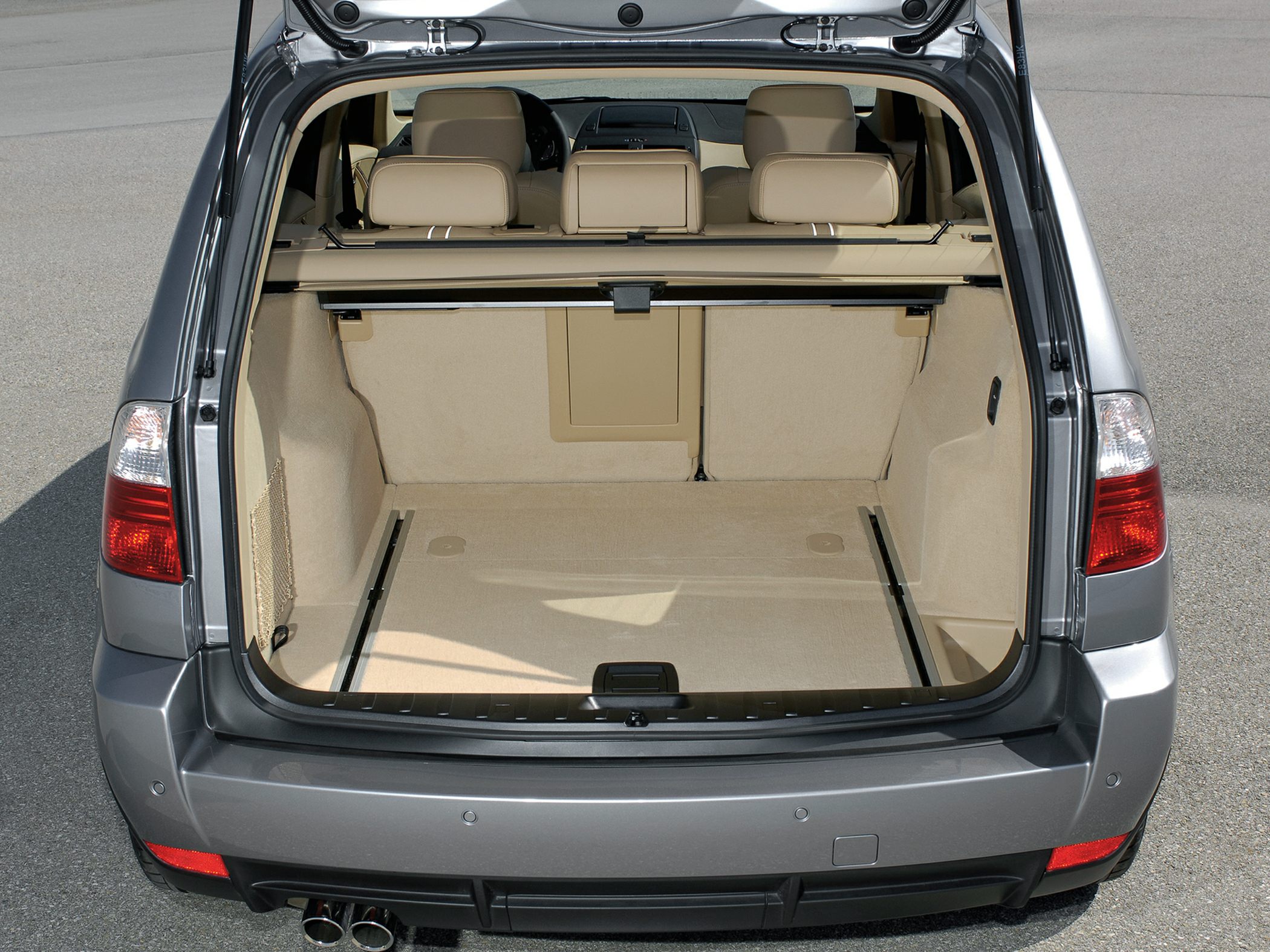 Spacious beige rear cargo area with foldable seats and retractable cover