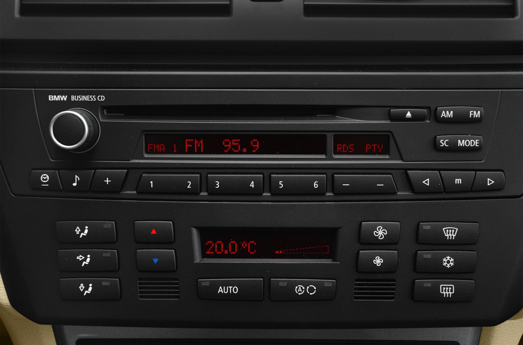 Close-up of car audio system and climate control panel with digital temperature display