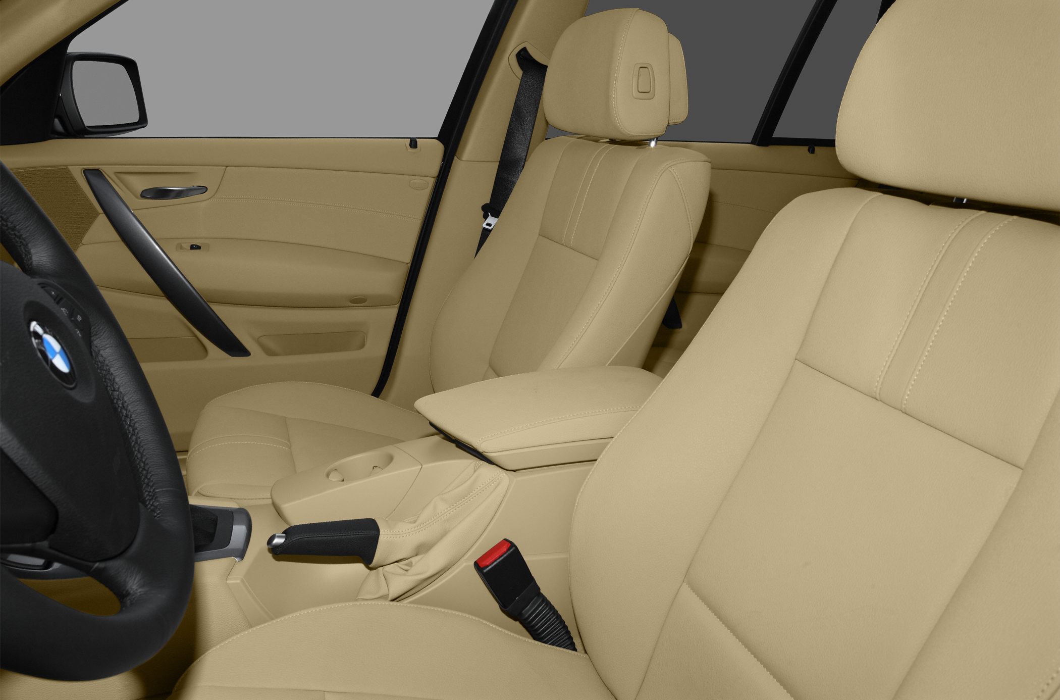 Beige leather front seats with armrest and door panel interior details