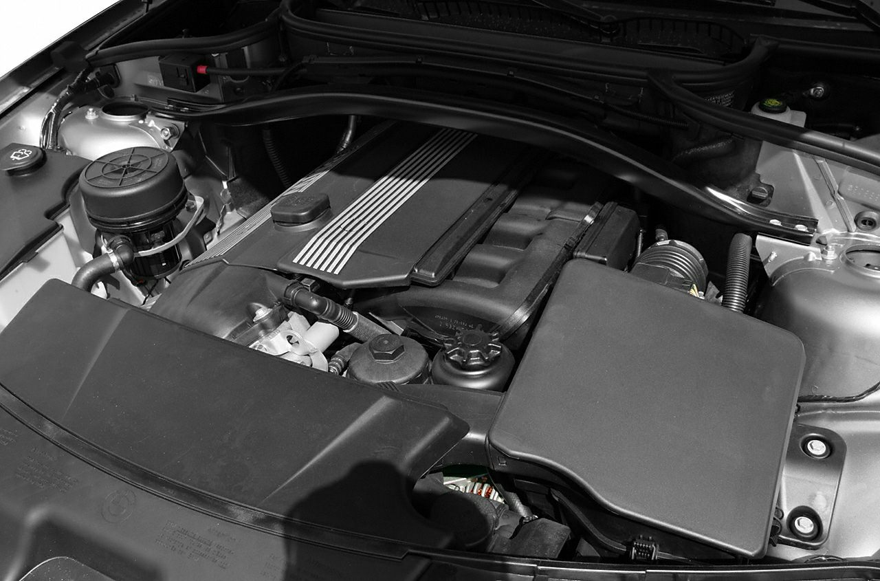 Clean and organized engine bay with exposed engine cover and surrounding components