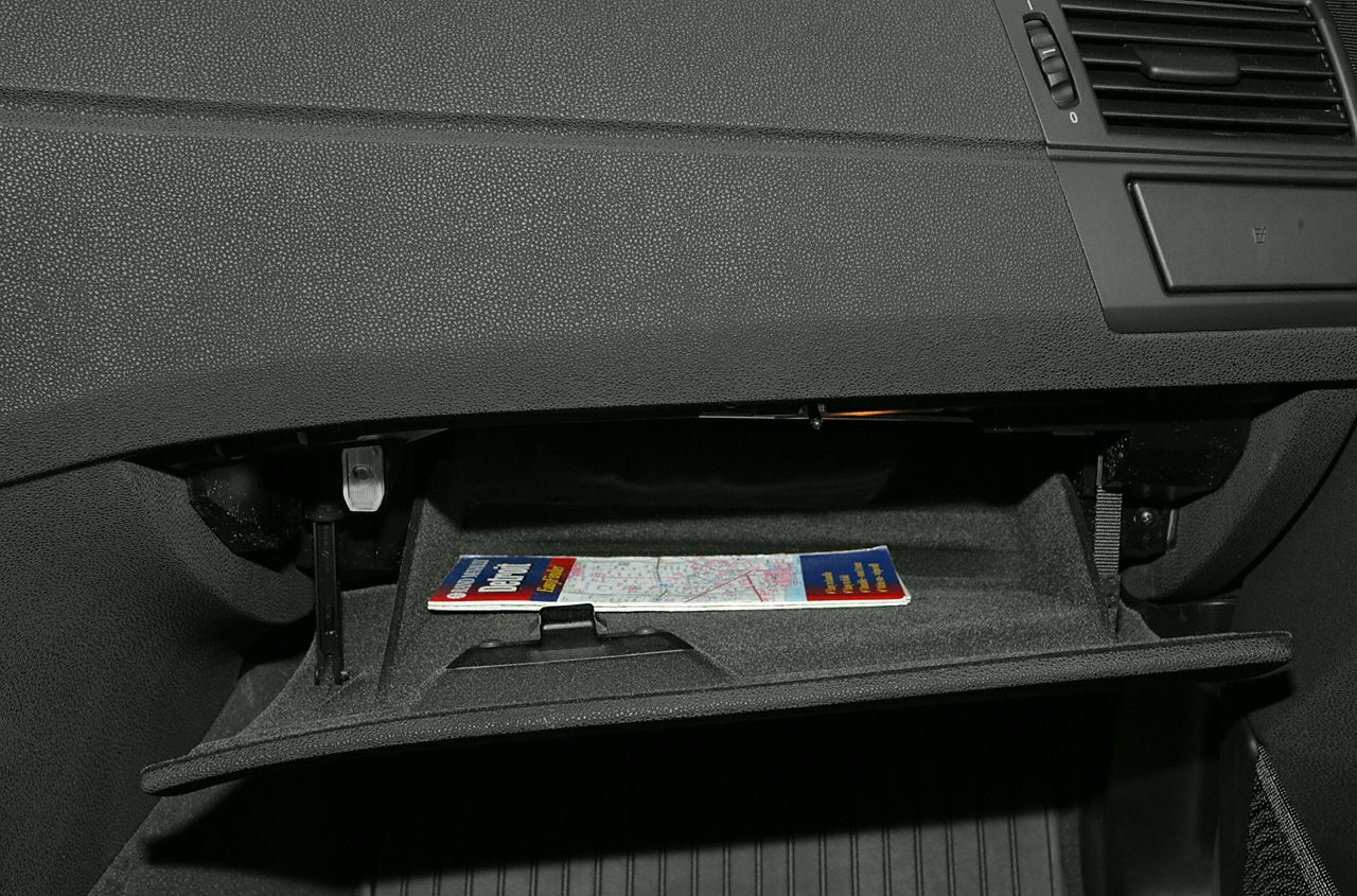 Open glove compartment with storage space and map inside