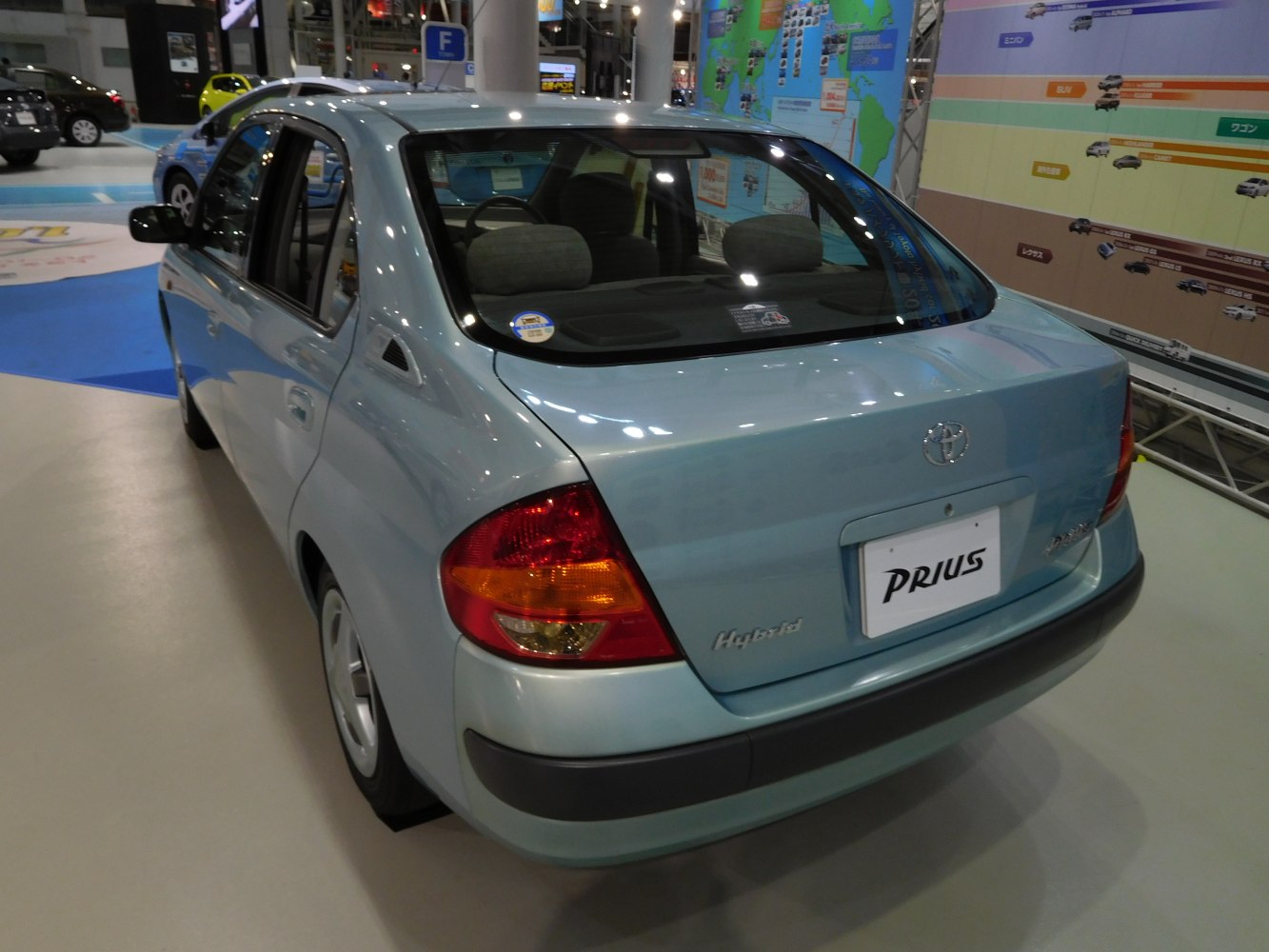 Rear angle of a compact hybrid sedan with hybrid badge and distinctive taillights.