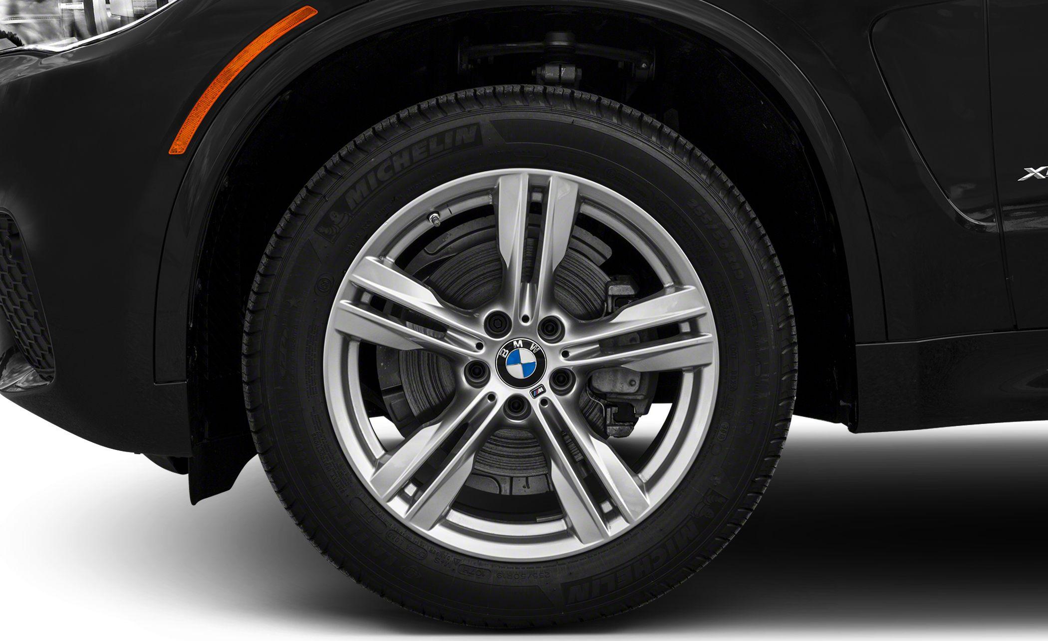 Alloy wheel with Michelin tire and visible brake disc, side marker light.