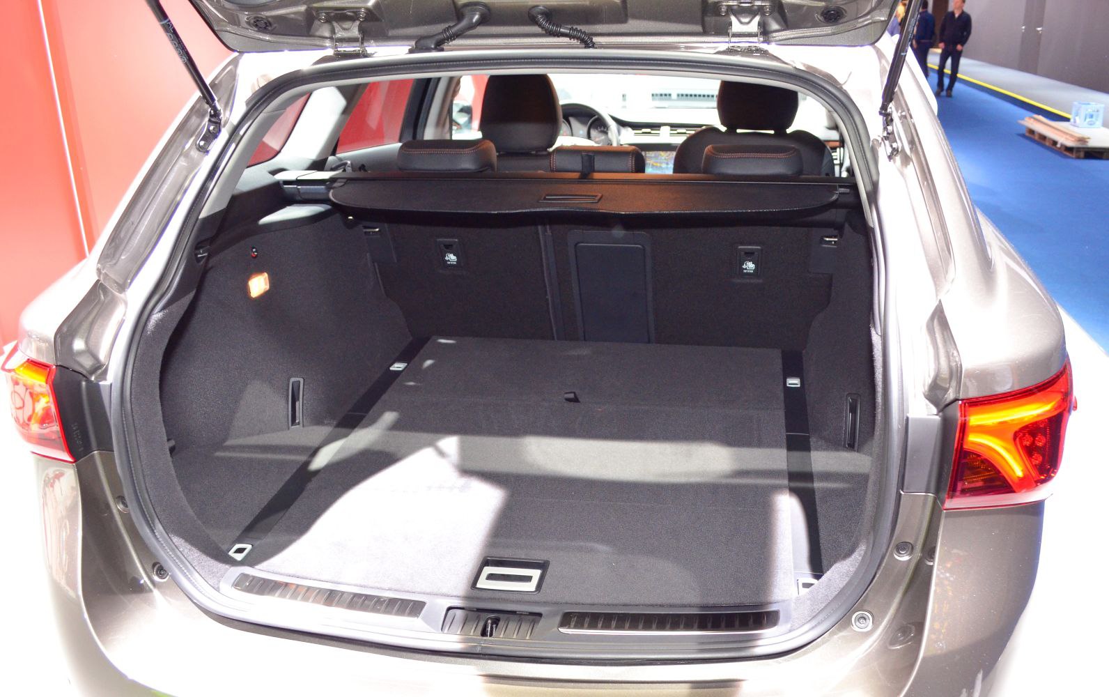 Spacious wagon trunk area with rear seats and foldable cover visible