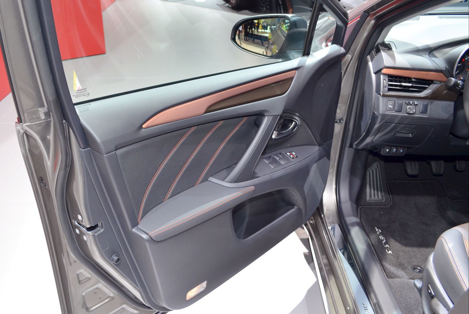 Interior door panel with controls and upholstery details