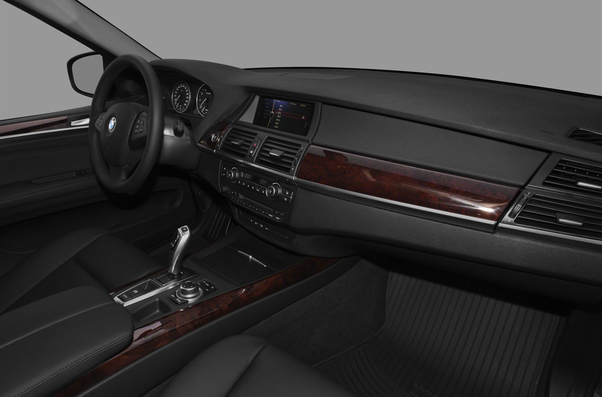 Luxury interior with wood trim dashboard and center console controls
