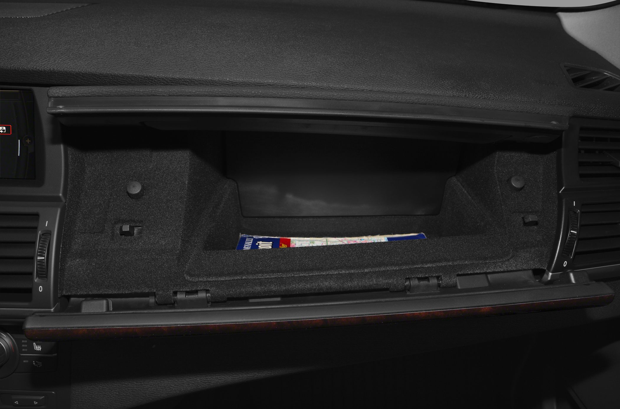 Open glove compartment with soft lining and map inside
