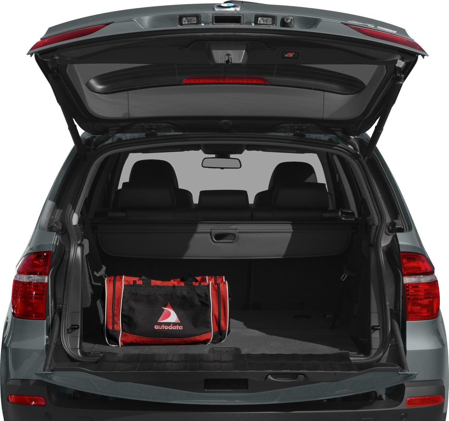 Open rear trunk with cargo cover and red-black bag.