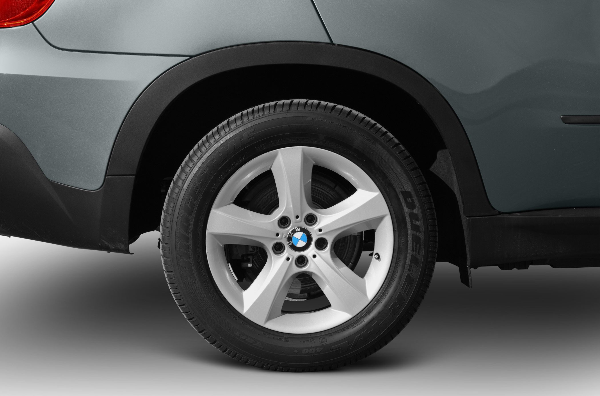Close-up of a rear alloy wheel with Bridgestone tire and wheel arch