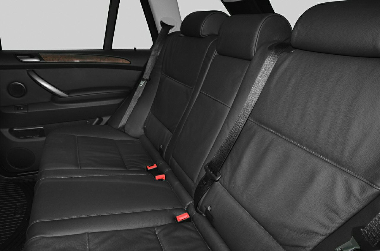 Black leather rear seat with seat belts inside a vehicle