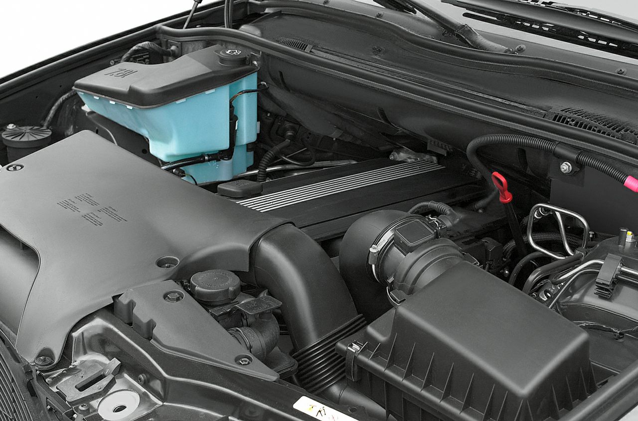 Engine compartment showcasing air intake system and engine cover.