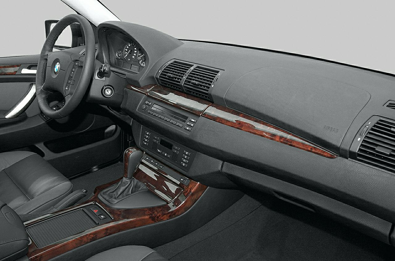 Dashboard with wood trim and manual gear shift in luxury SUV interior