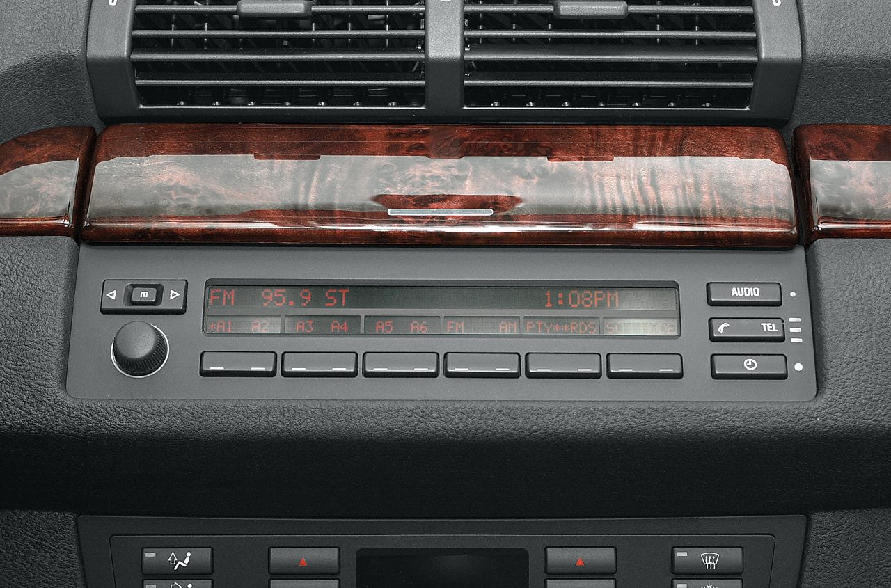 Wood trim radio control panel with dashboard air vents
