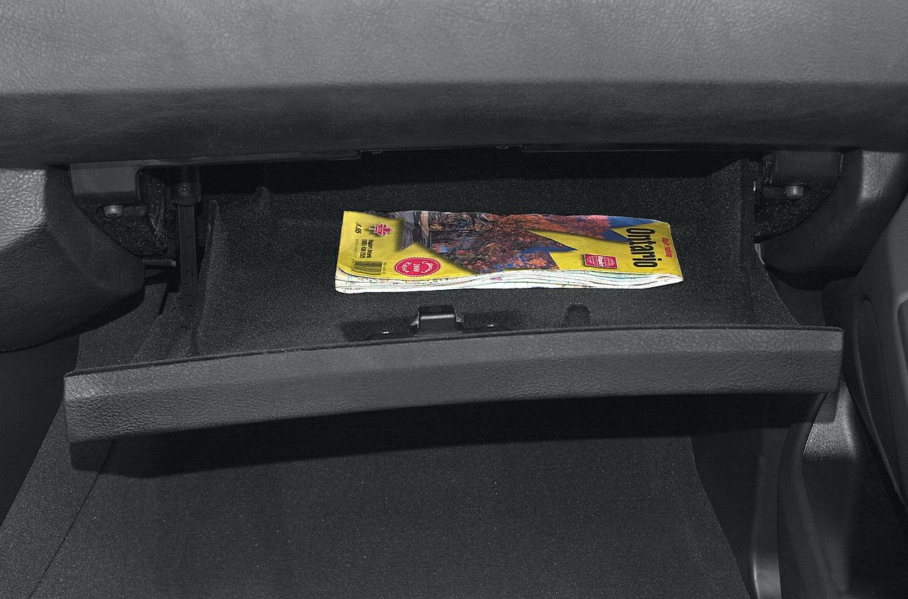Open glove compartment with folded map inside