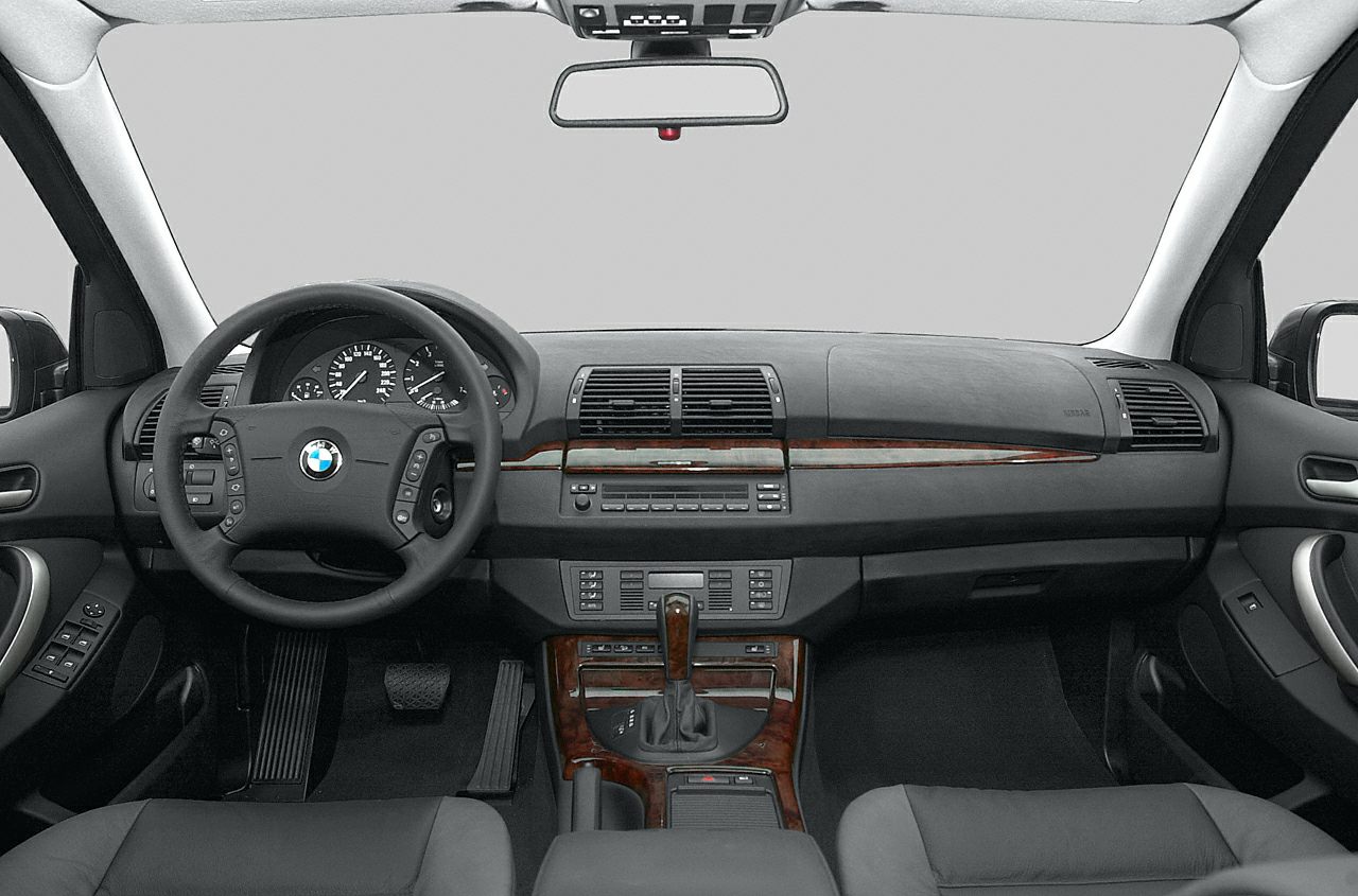 Dashboard with wood trim, instrument cluster, steering wheel, and center console