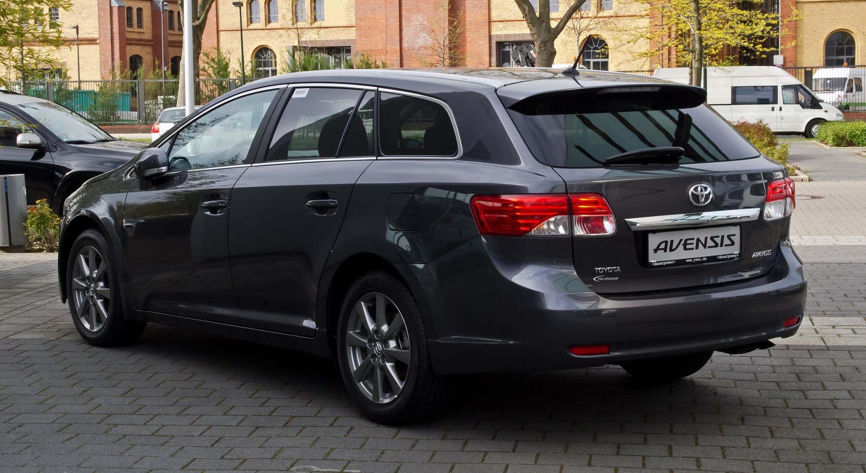 Rear side view of station wagon with tail lights and alloy wheels