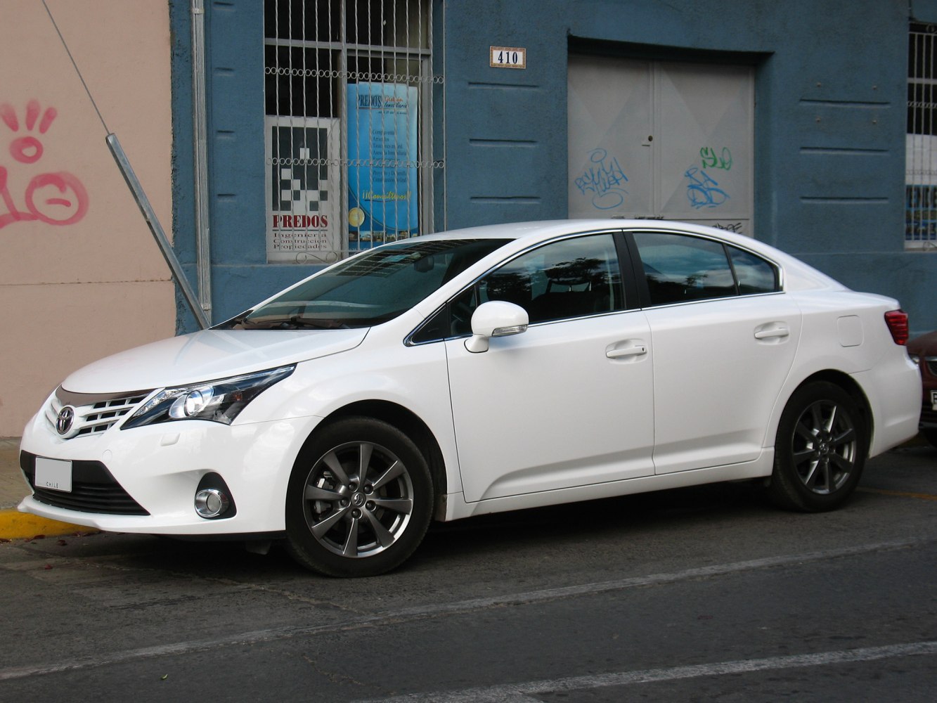 White sedan side view with LED headlights and alloy wheels