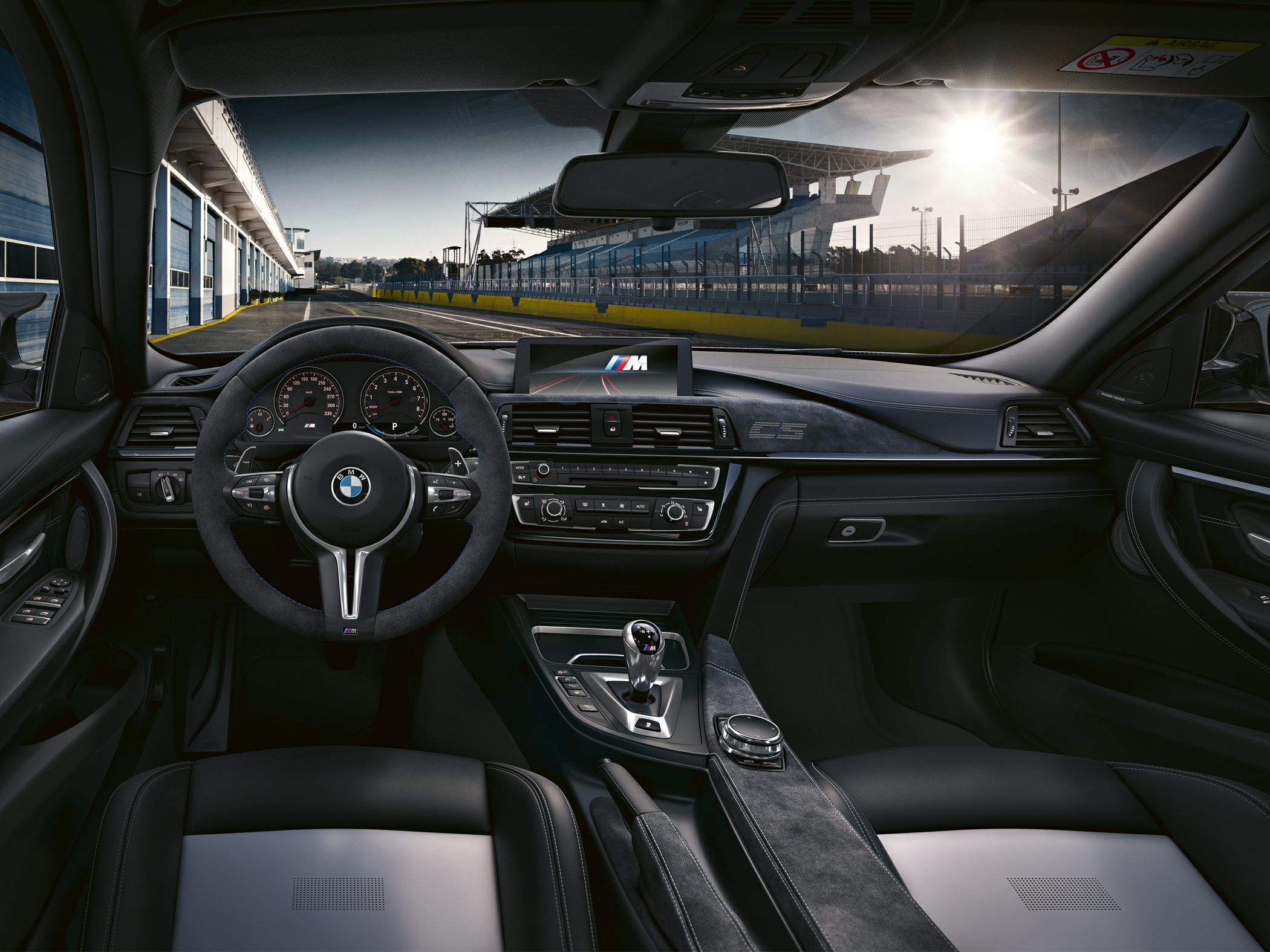 Sporty steering wheel and modern dashboard with digital display and center console.