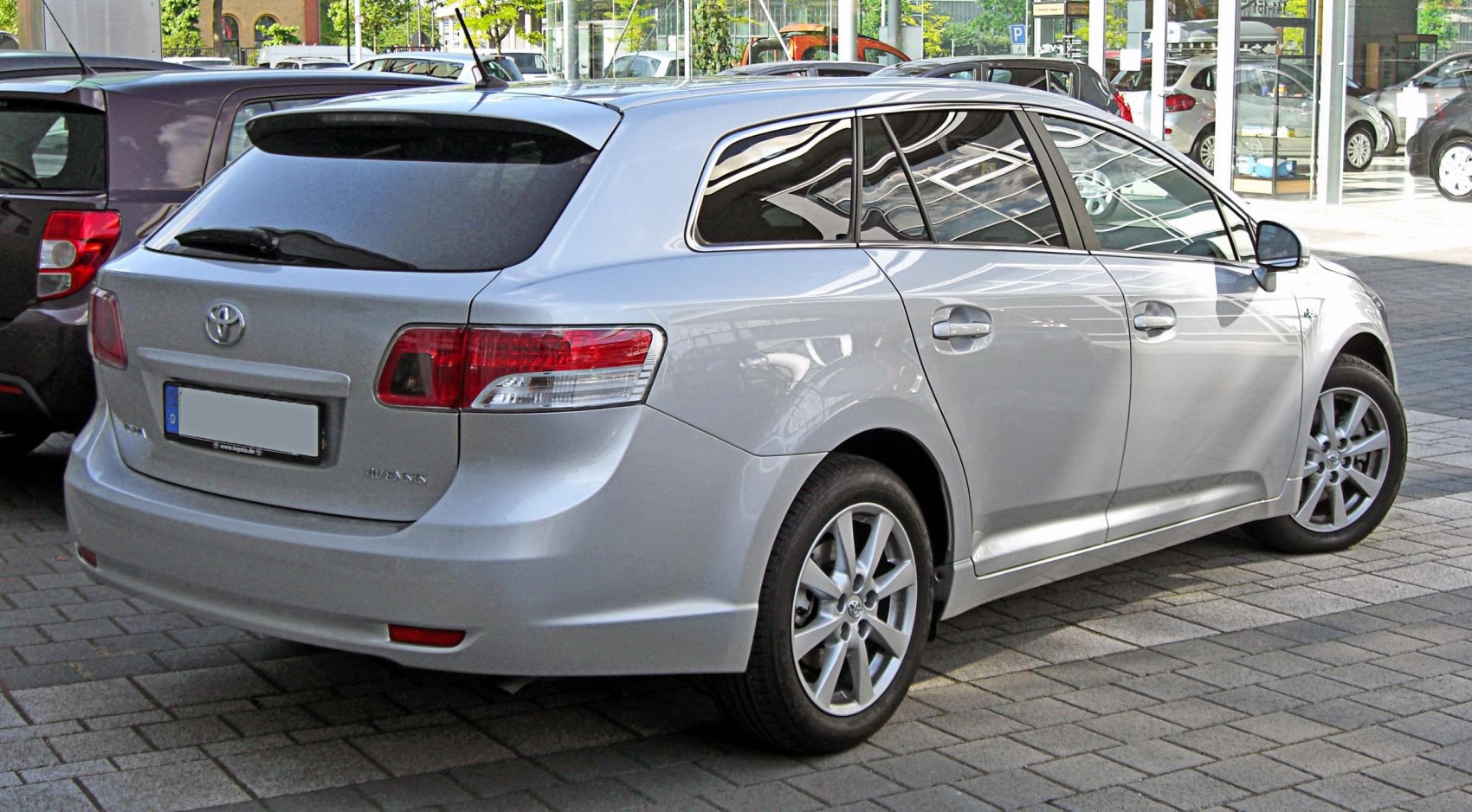 Silver station wagon rear side with taillights and tinted rear windows