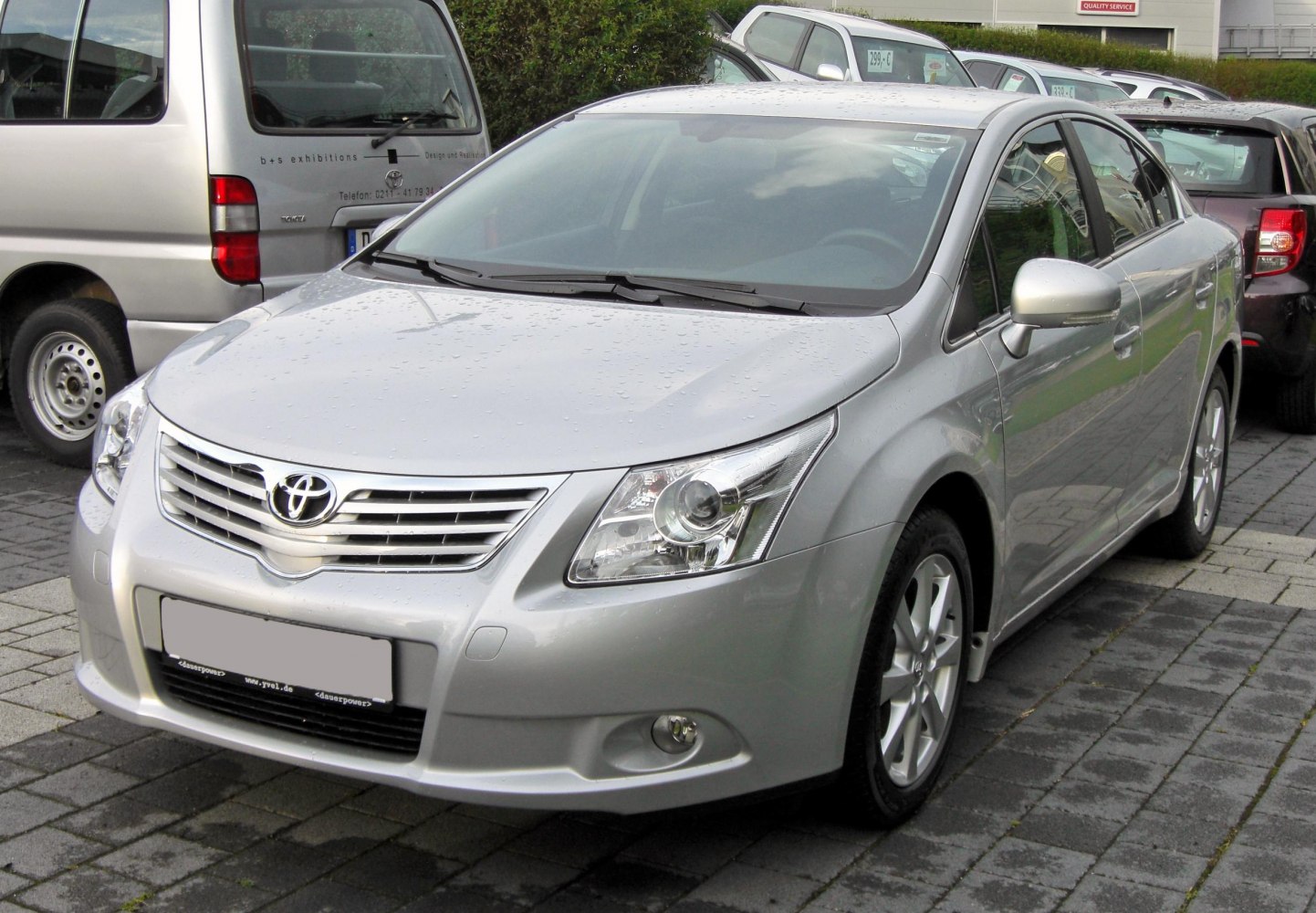 Silver sedan front with grille and modern headlights