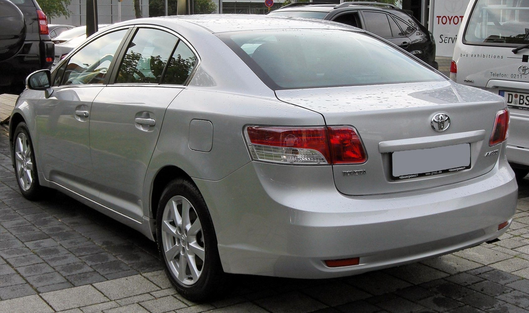Silver mid-size sedan rear side with modern taillights and streamlined body