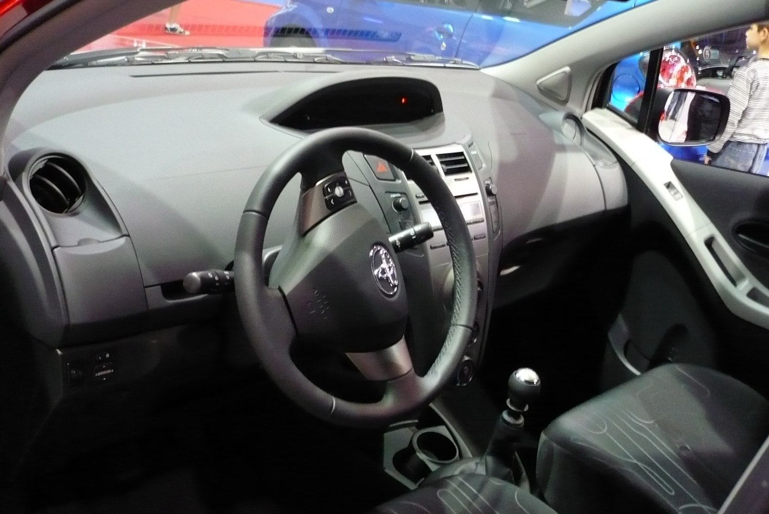 Dashboard with central digital display, steering wheel, and manual gear shift