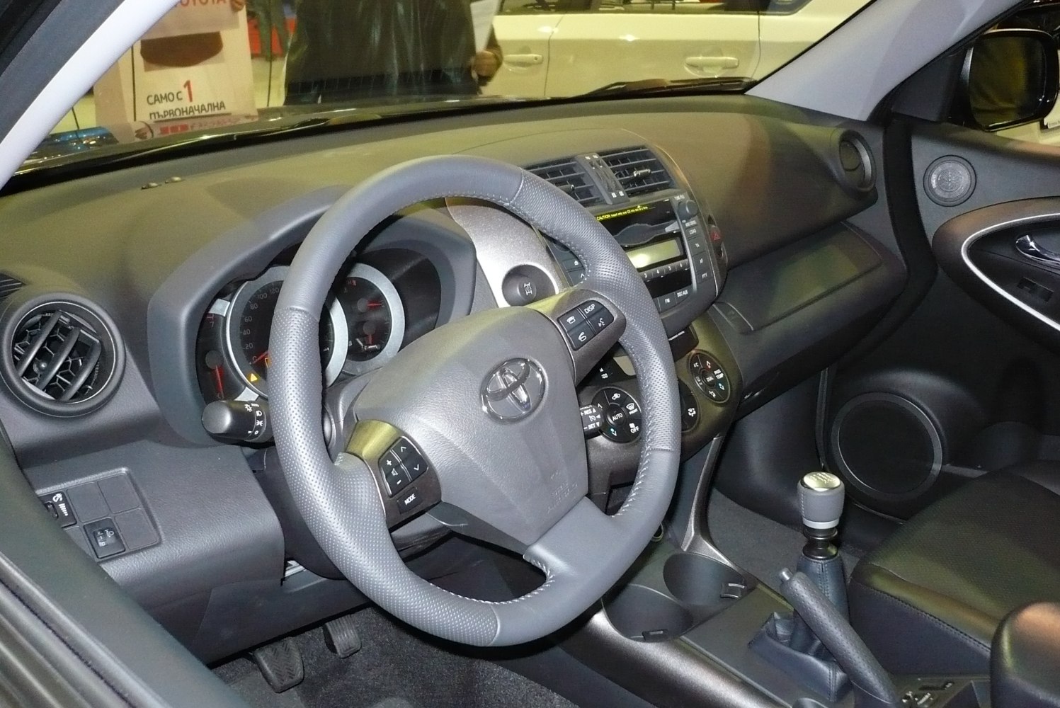 Steering wheel, dashboard, and manual gear shift close-up