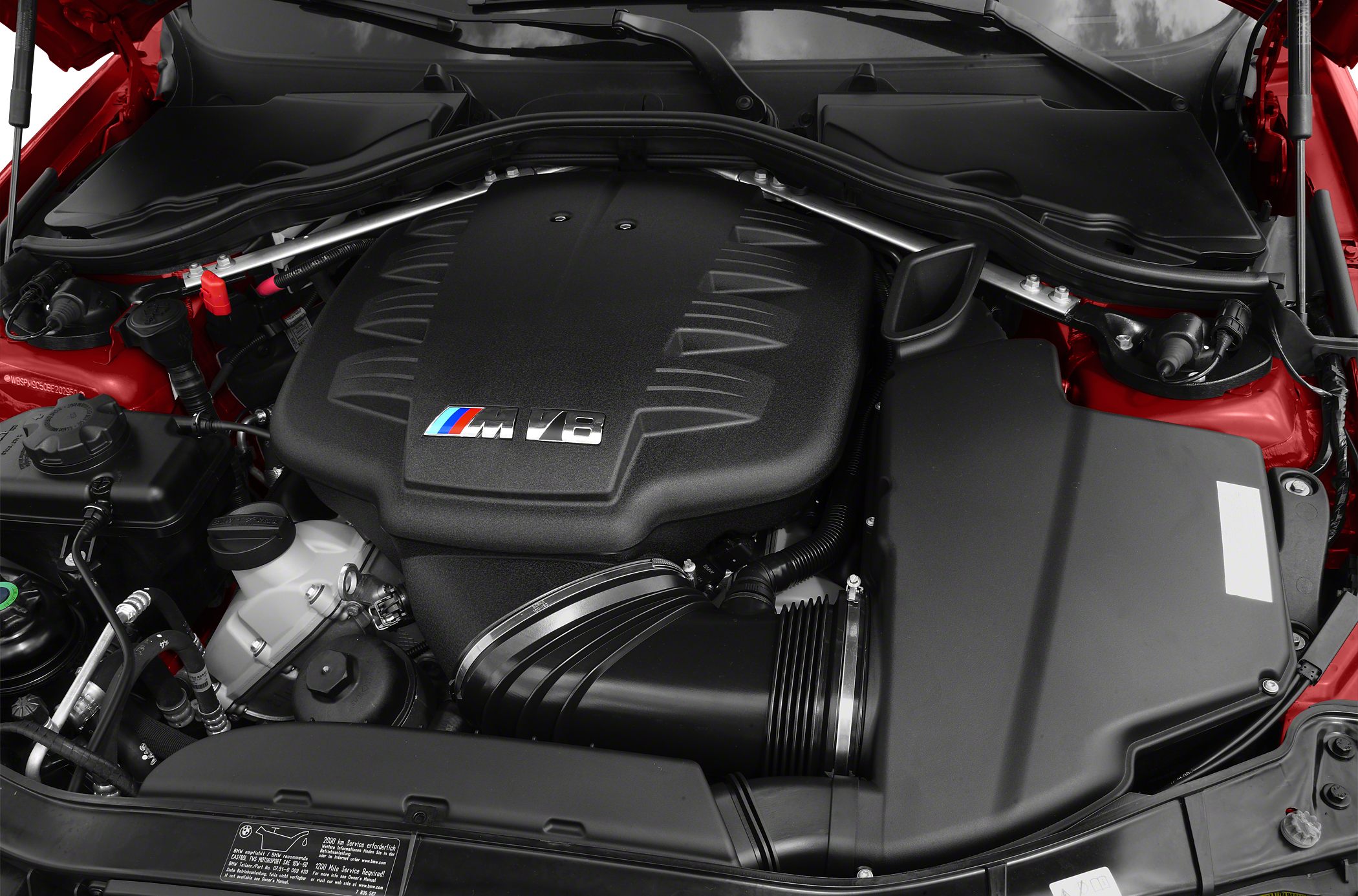 V8 engine compartment with intake and engine cover featuring M logo