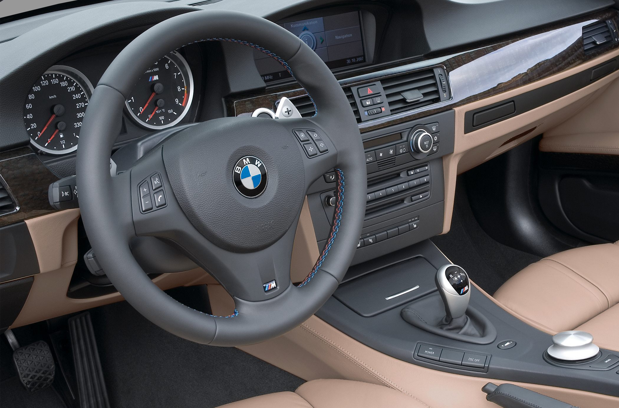 Steering wheel, dashboard, gear stick, and tan leather interior