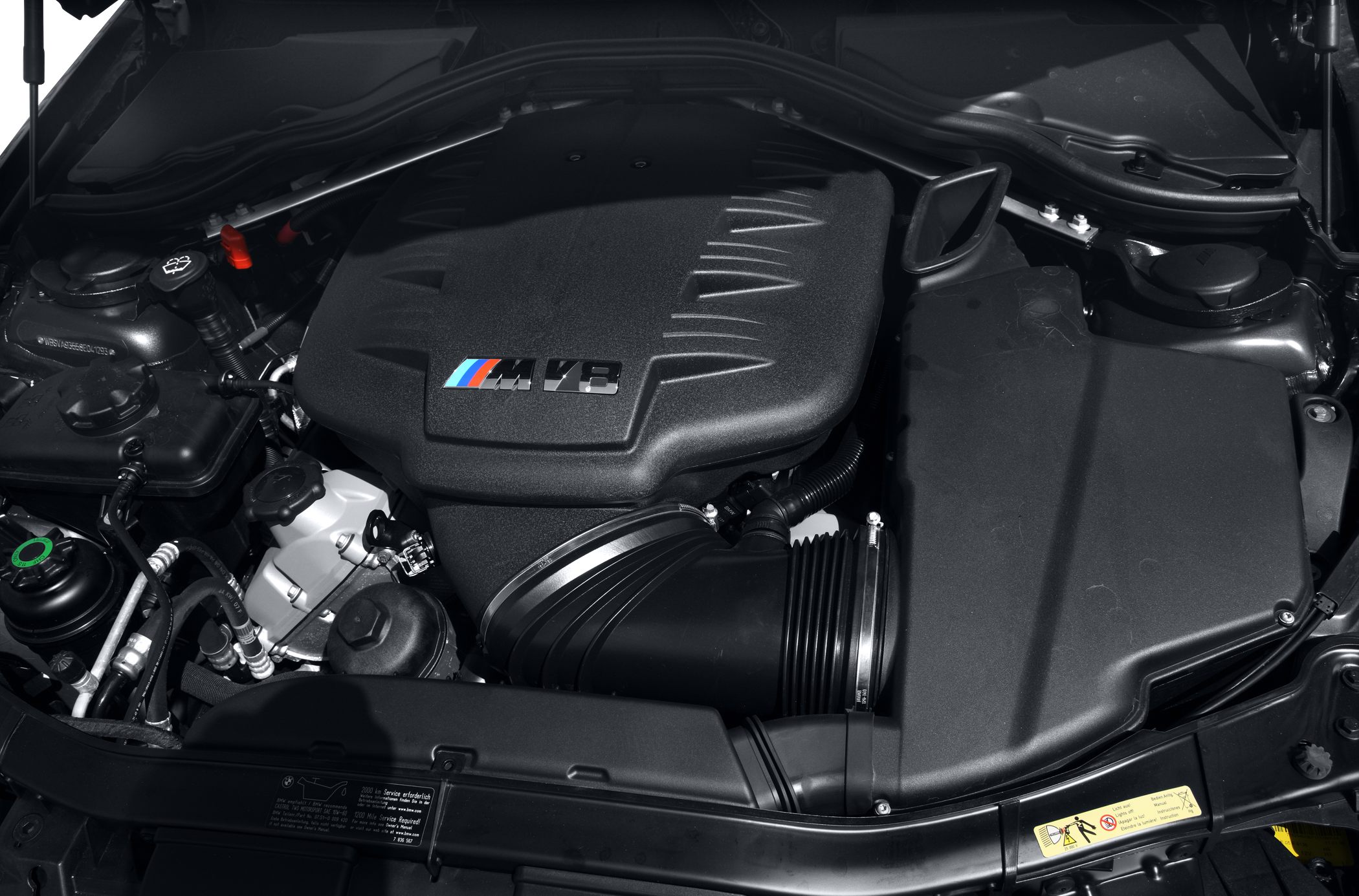 BMW E90 M3 engine bay with M V8 badge and air intake