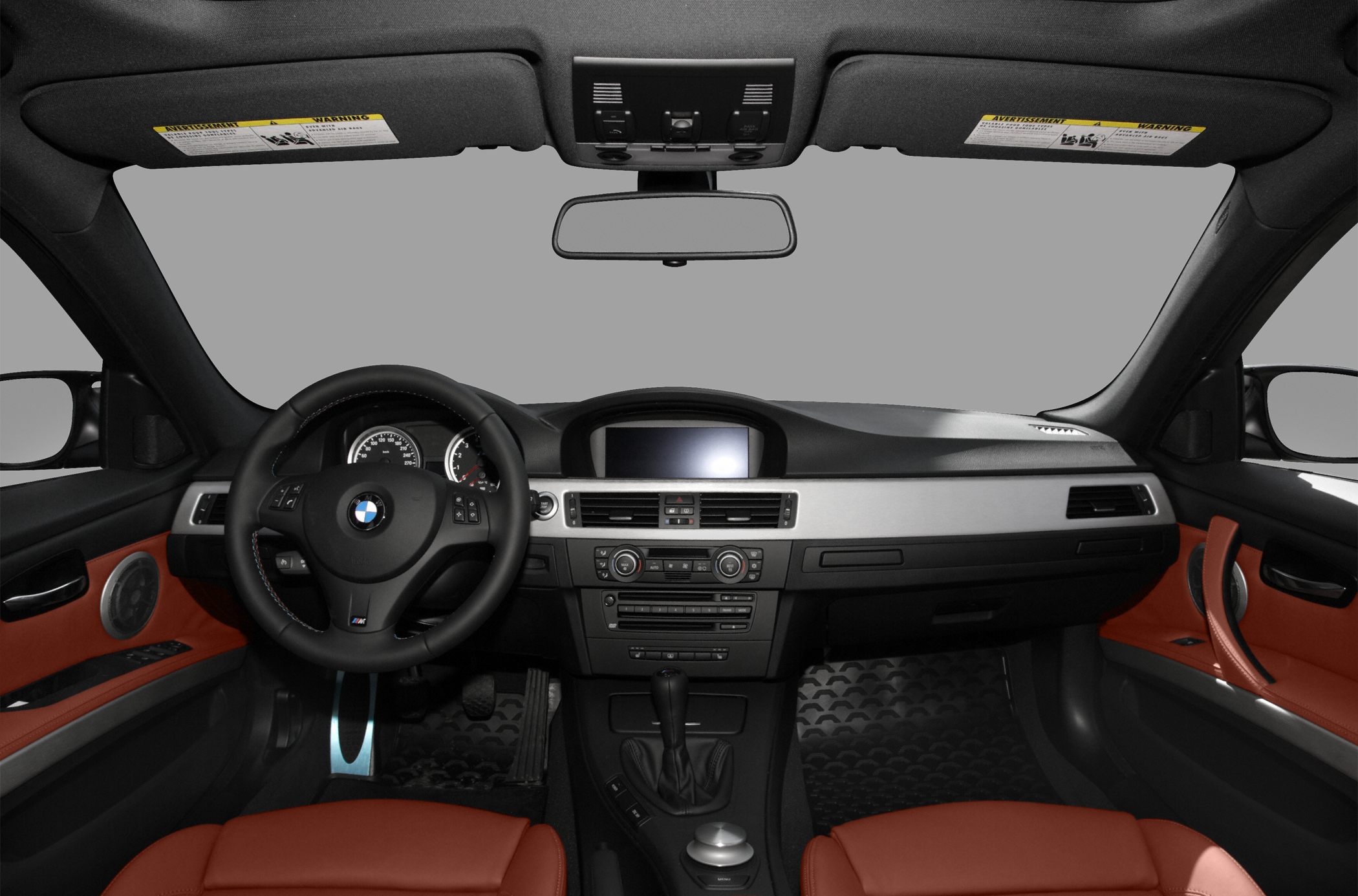 Interior view with dashboard, steering wheel, and orange leather seats