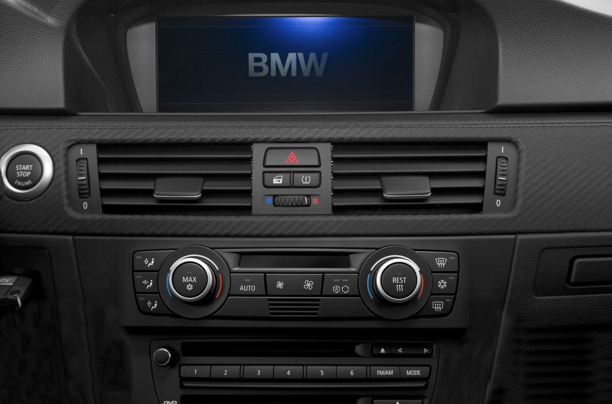 Dashboard with climate control, start/stop button, and central display