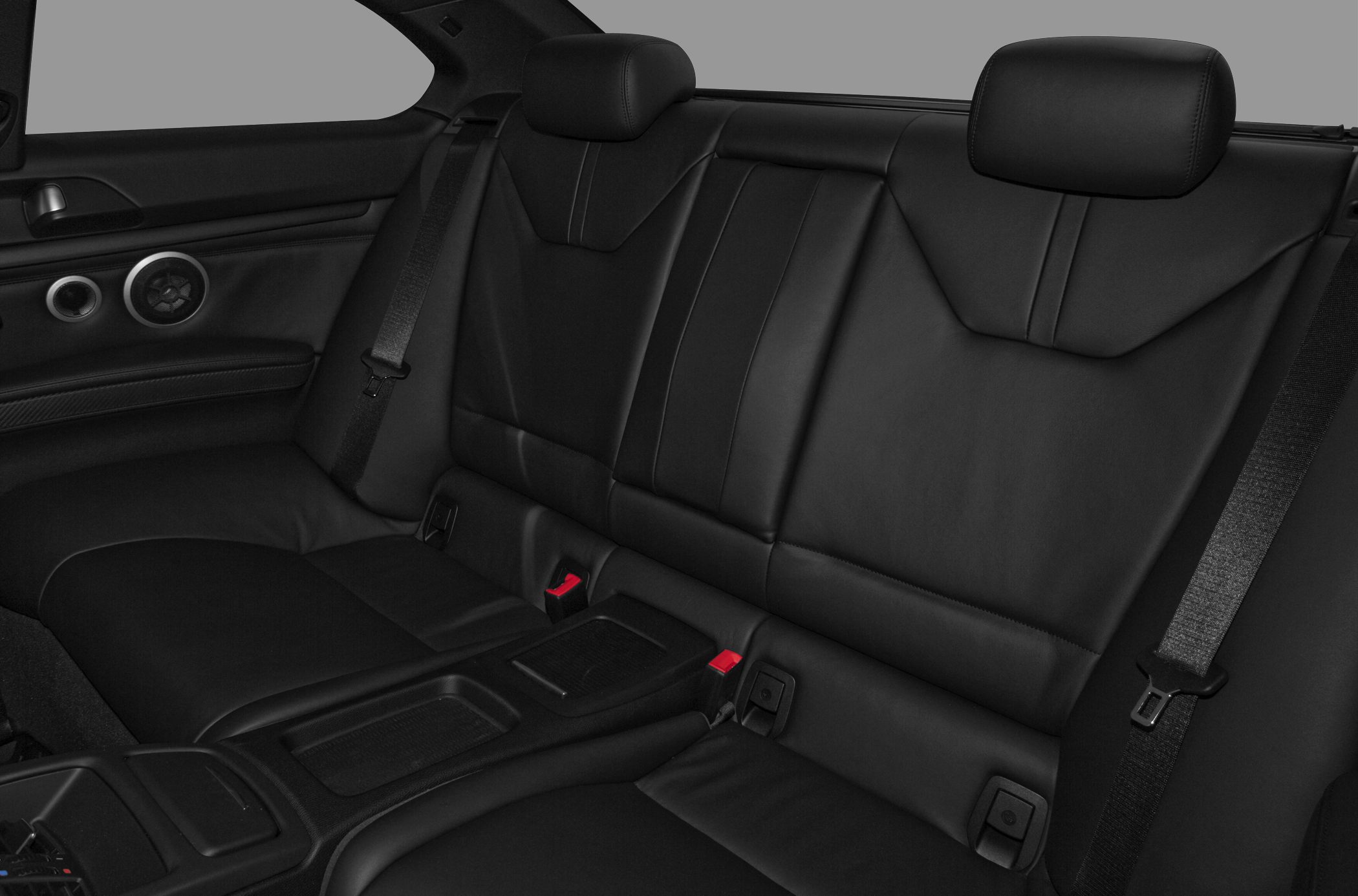 Rear leather seats with headrests and seat belts in a coupe interior