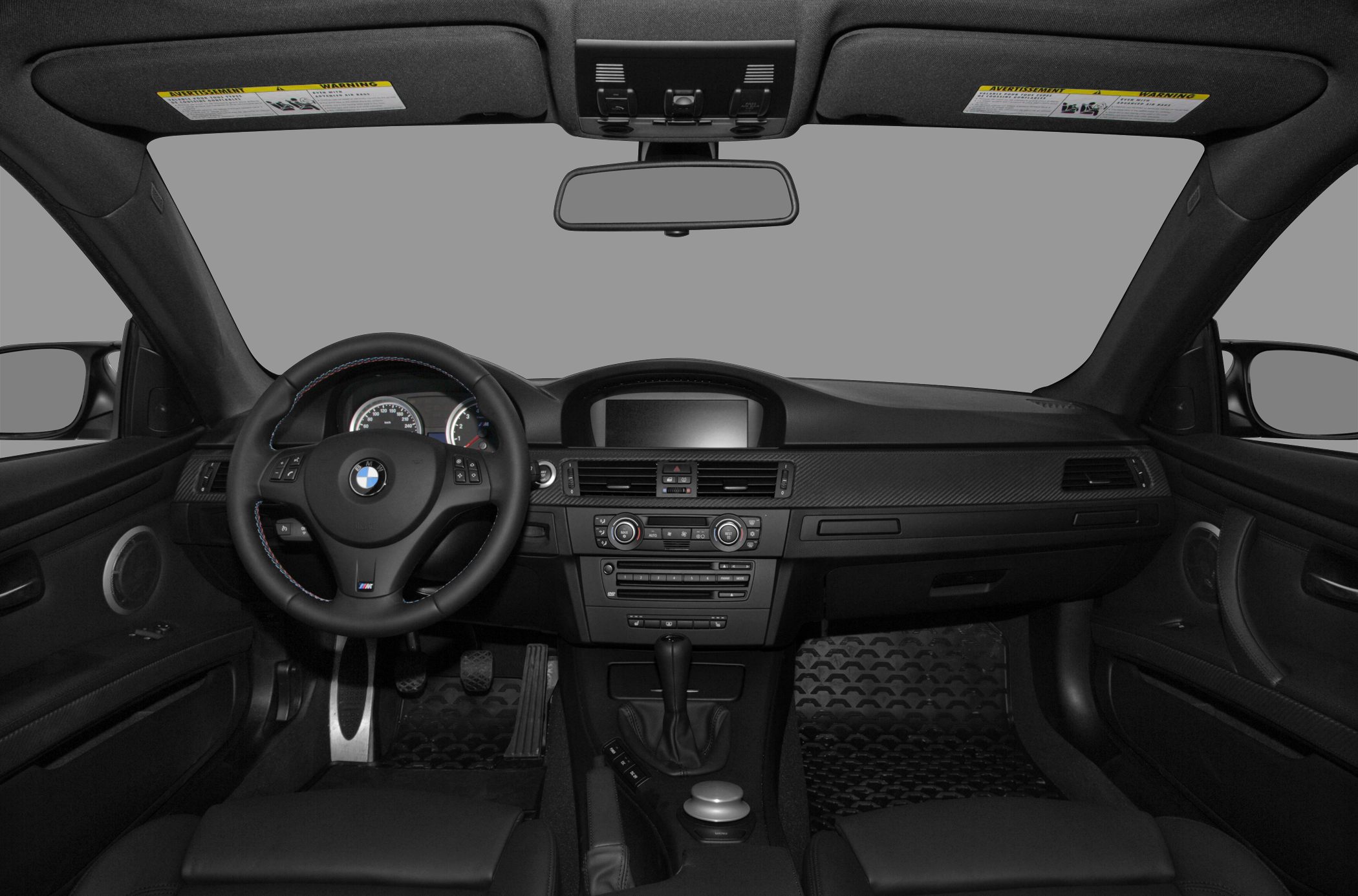 Dashboard and steering wheel with center console and pedals.