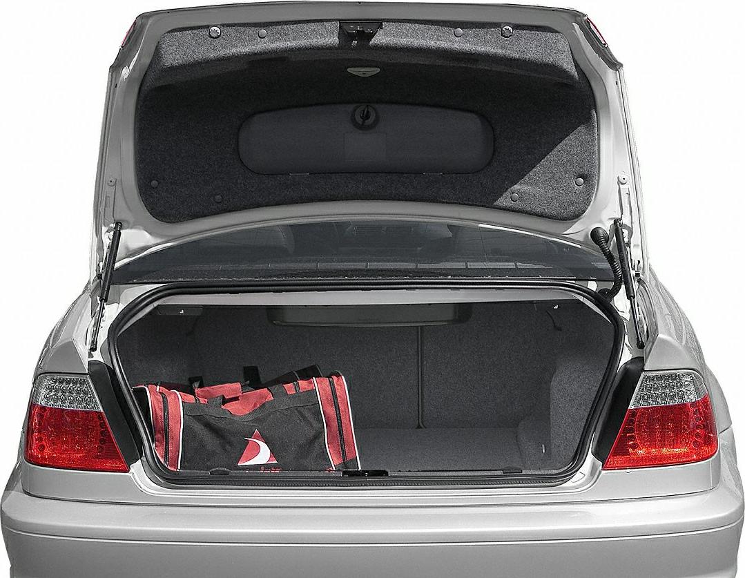 Open trunk space with a red and black bag under opened trunk lid.