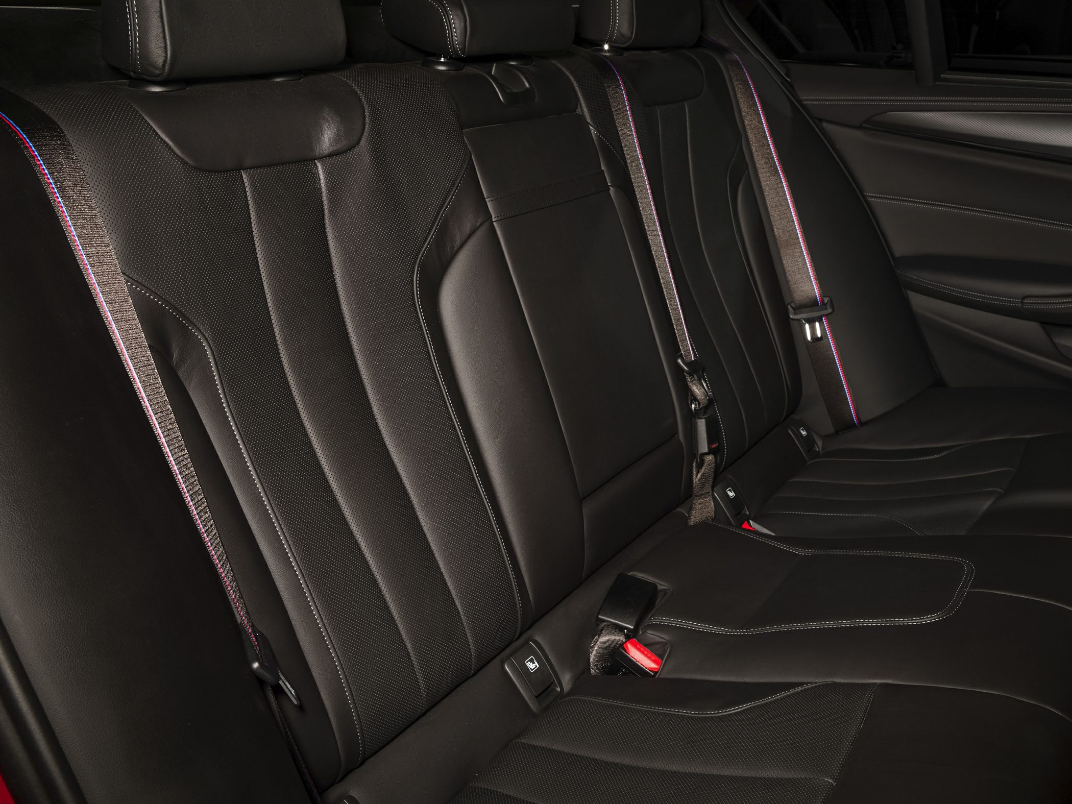 Rear seats with black leather upholstery and distinct stitching details.