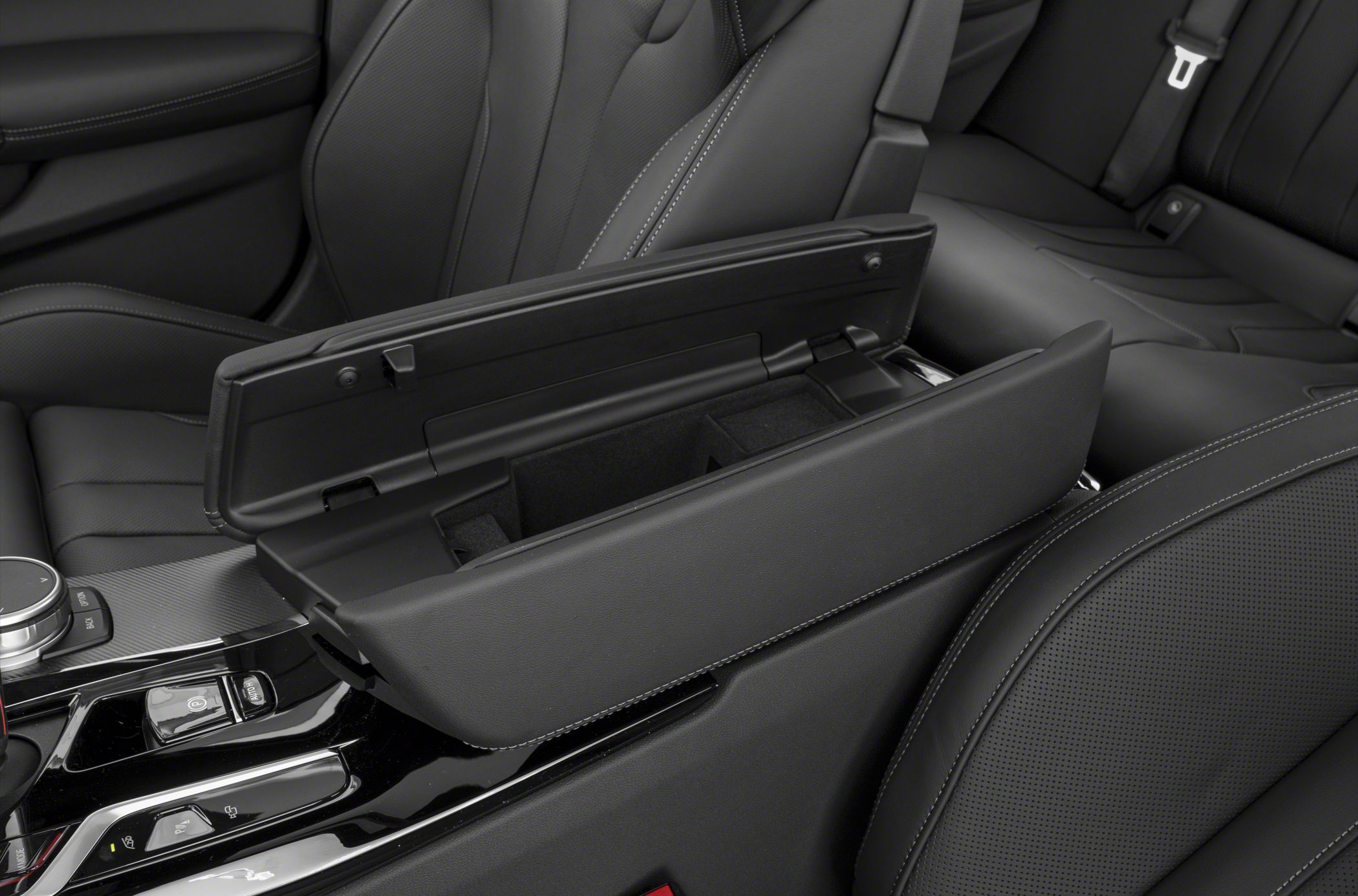 Open center armrest storage cubby in black leather interior