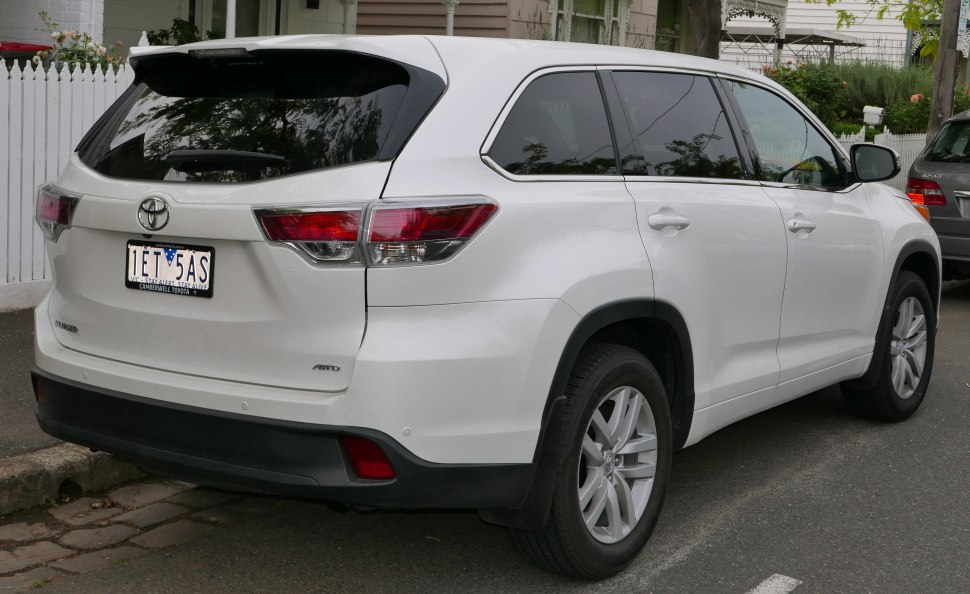 Rear angle of white SUV highlighting tail lights and AWD badge