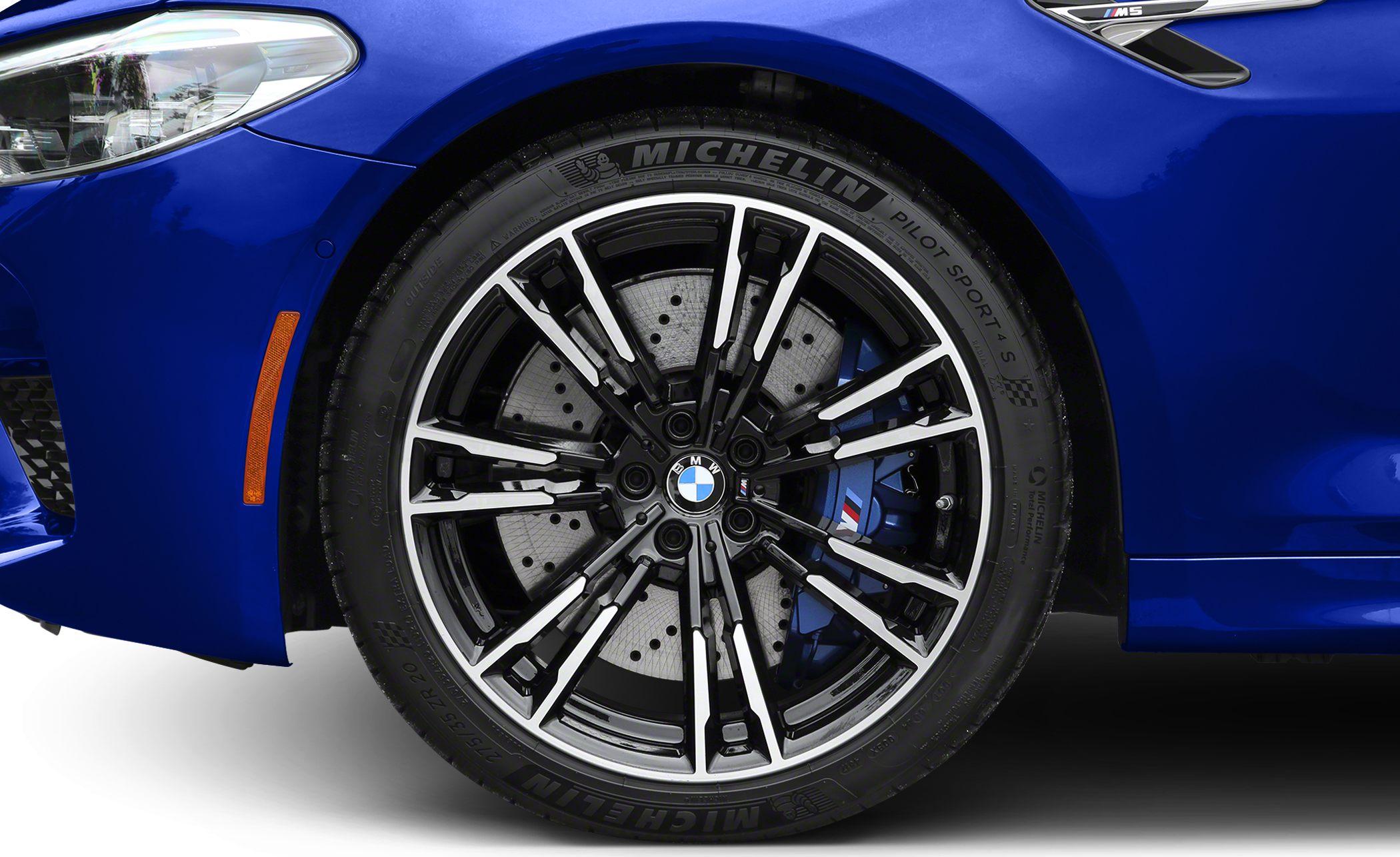 Close-up of alloy wheel, drilled rotor, and blue brake caliper