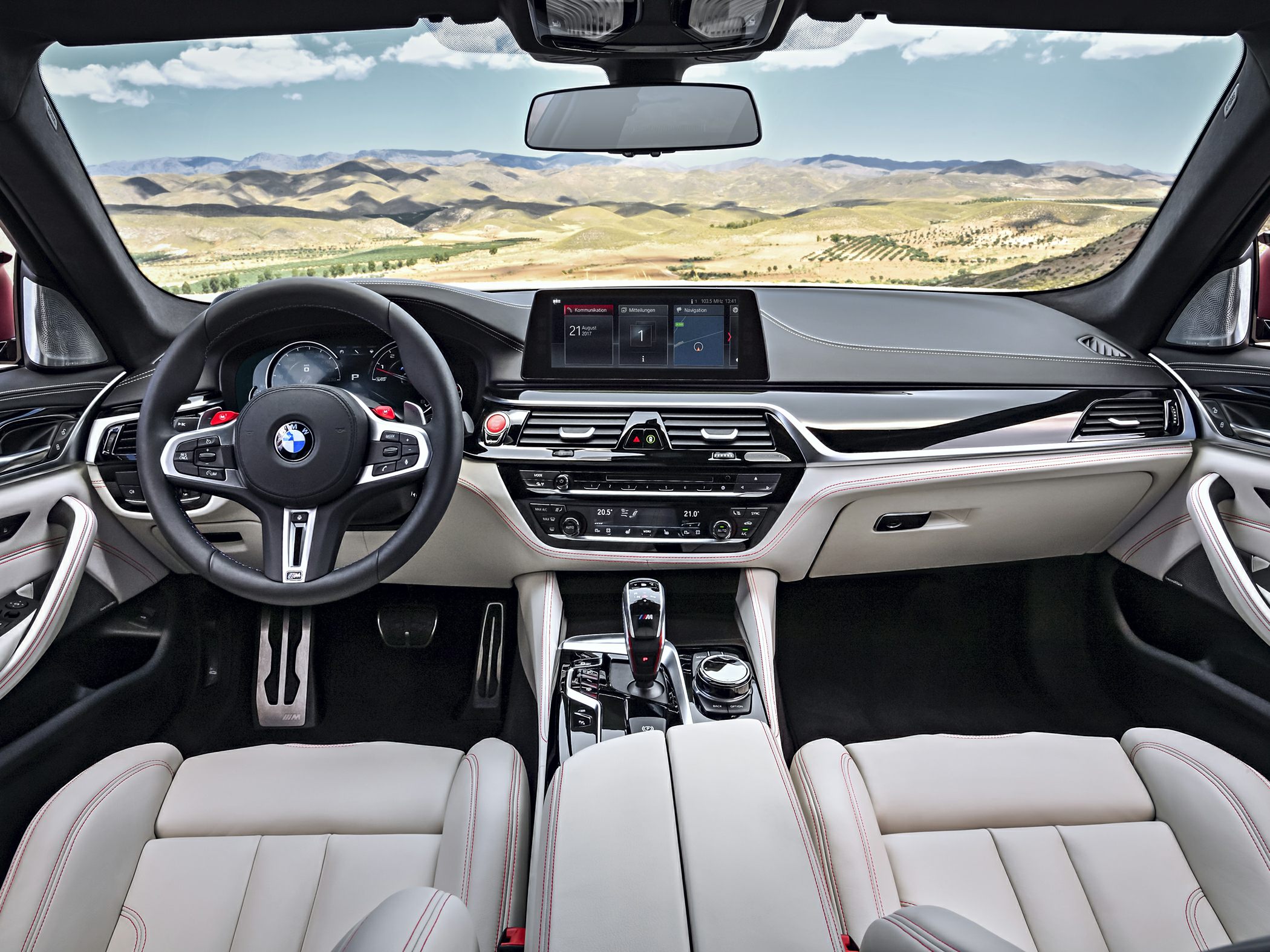 Luxury car interior with dashboard and sport steering wheel