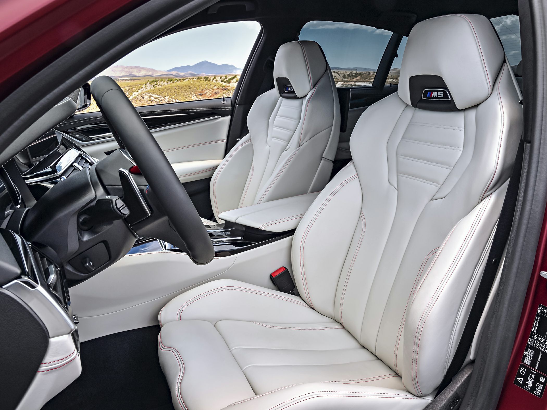 White leather sport seats with M5 logo and red stitching