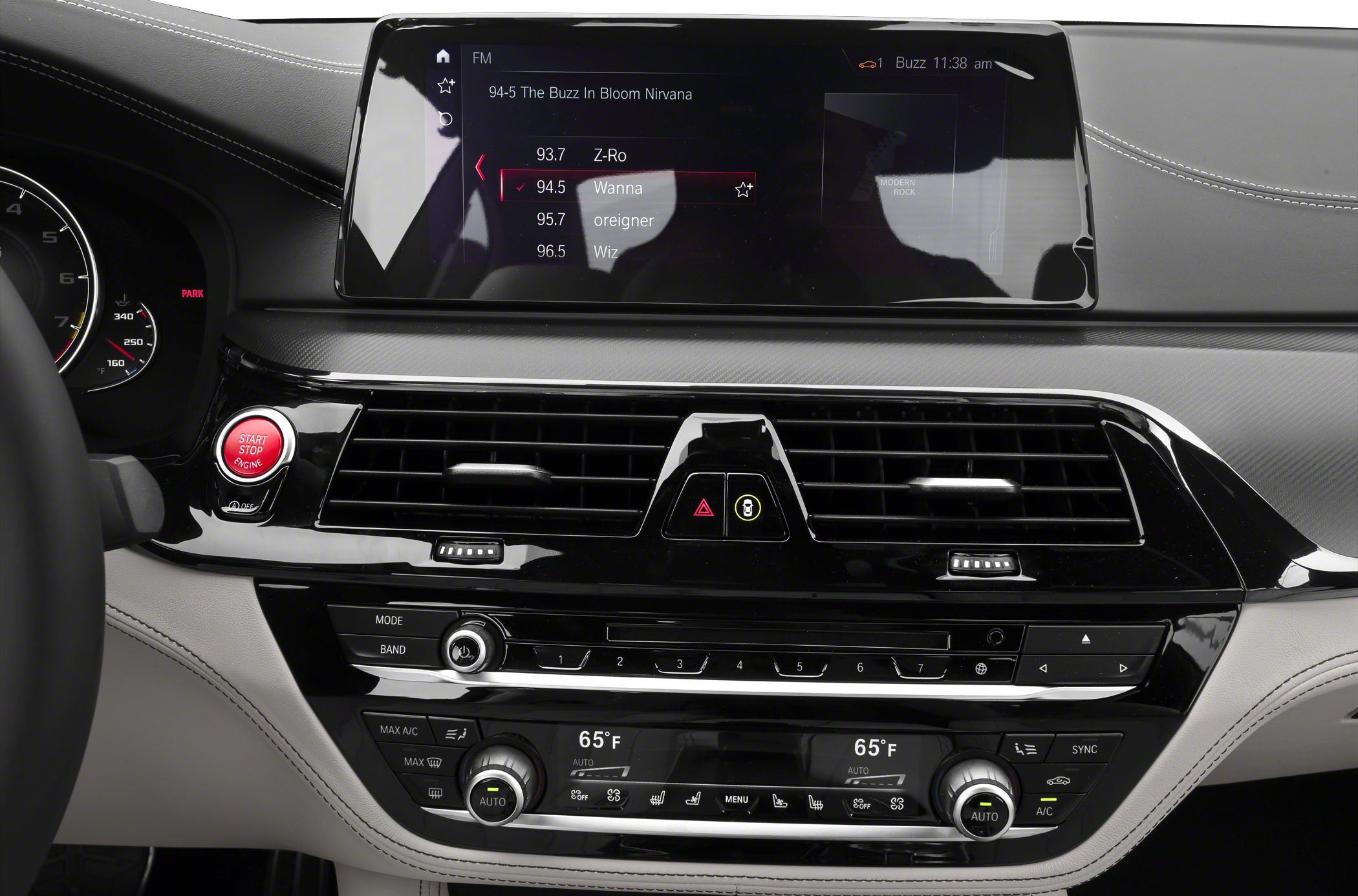 Digital infotainment screen, climate control knobs, engine start/stop button